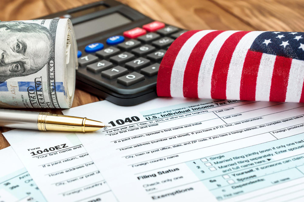 U.S. tax documents with calculator, dollar bills, and American flag — representing professional tax filing services.