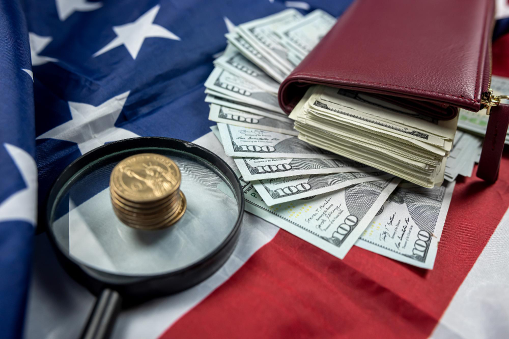 U.S. flag with dollar bills, a magnifying glass, and tax documents symbolizing federal tax credits and financial management.