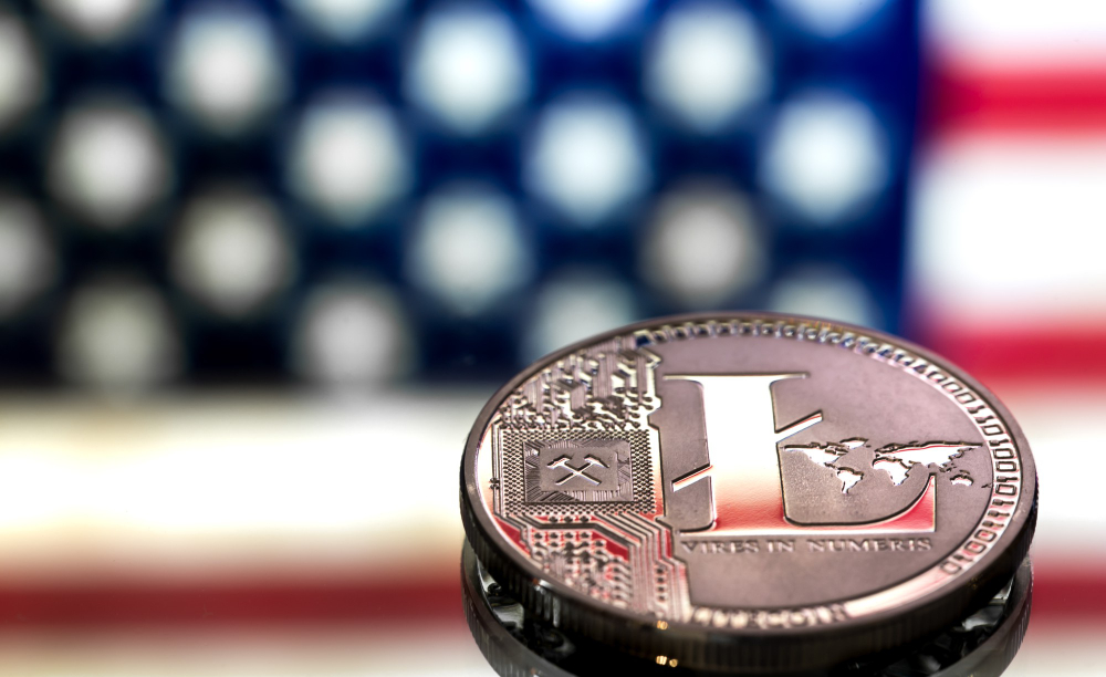 Close-up of a U.S. coin with the American flag in the background, representing the monetary influence of the Federal Reserve.