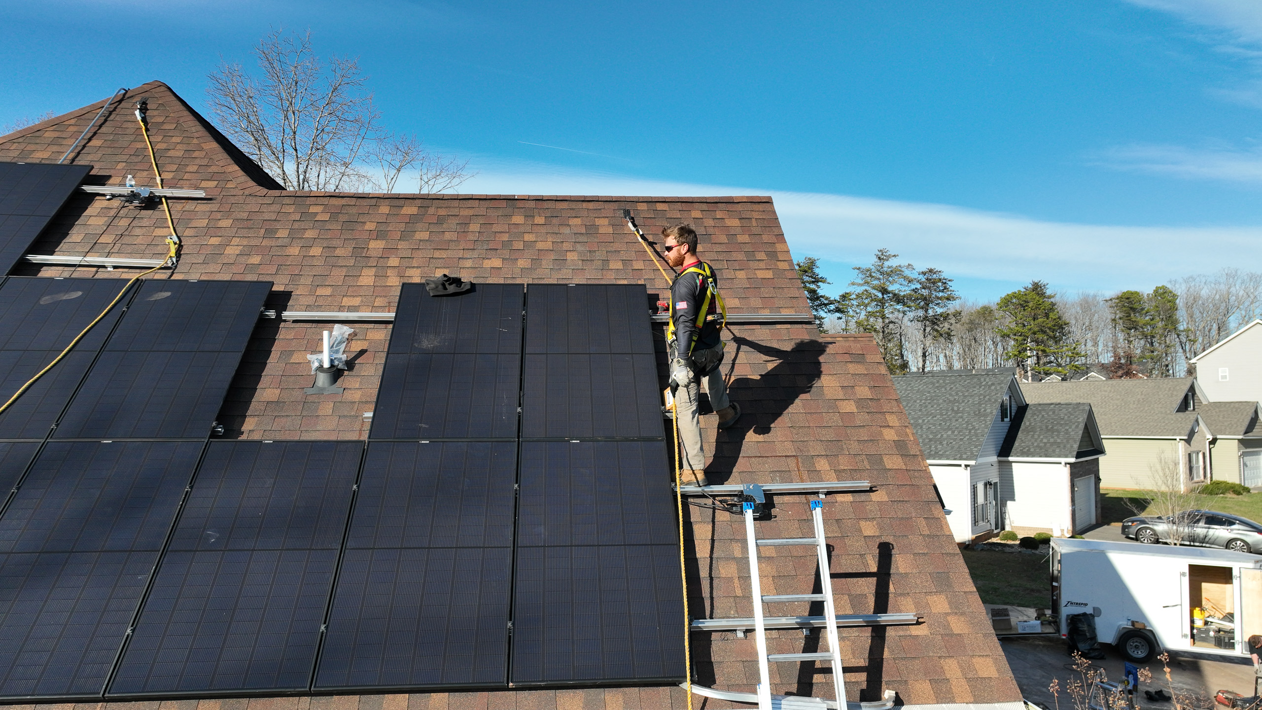 Man installing solar panel on roof