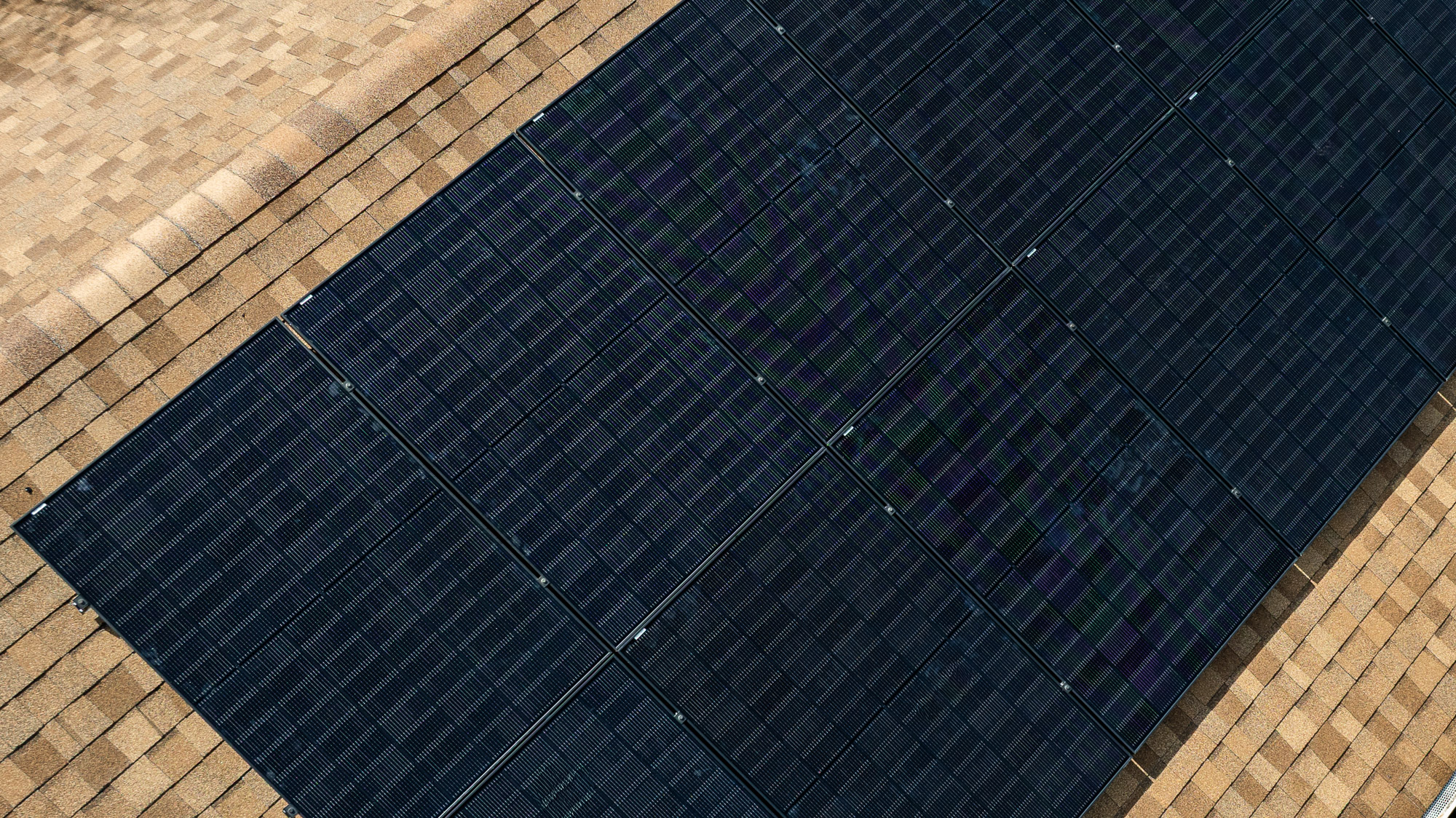 Man installing solar panel on roof