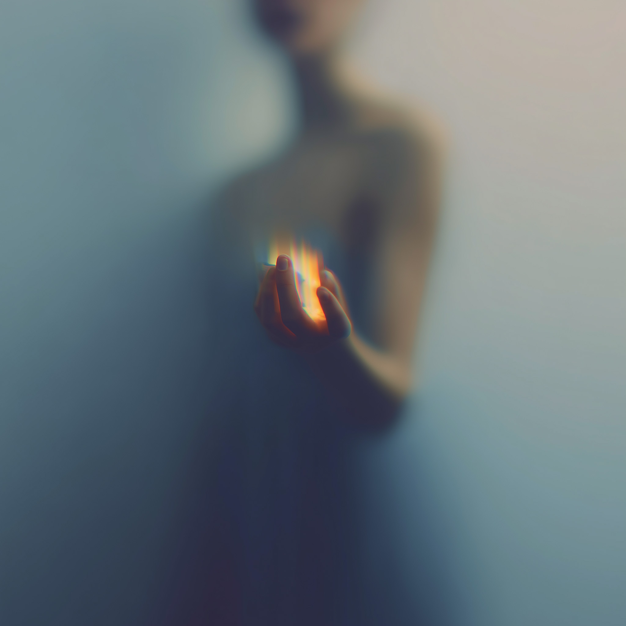 Softly lit hands representing compassionate individual support