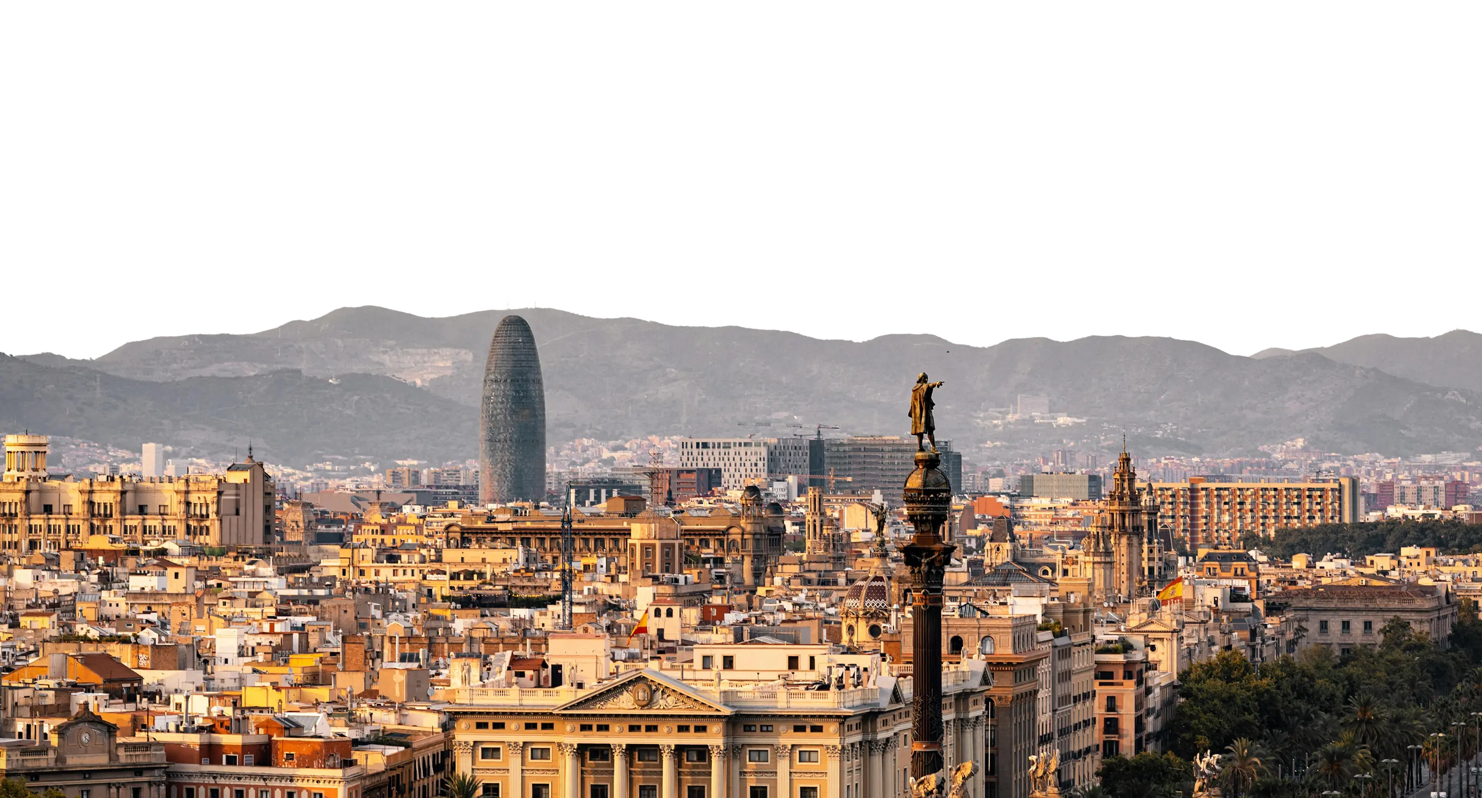 A view of a city with tall buildings and mountains in the background.