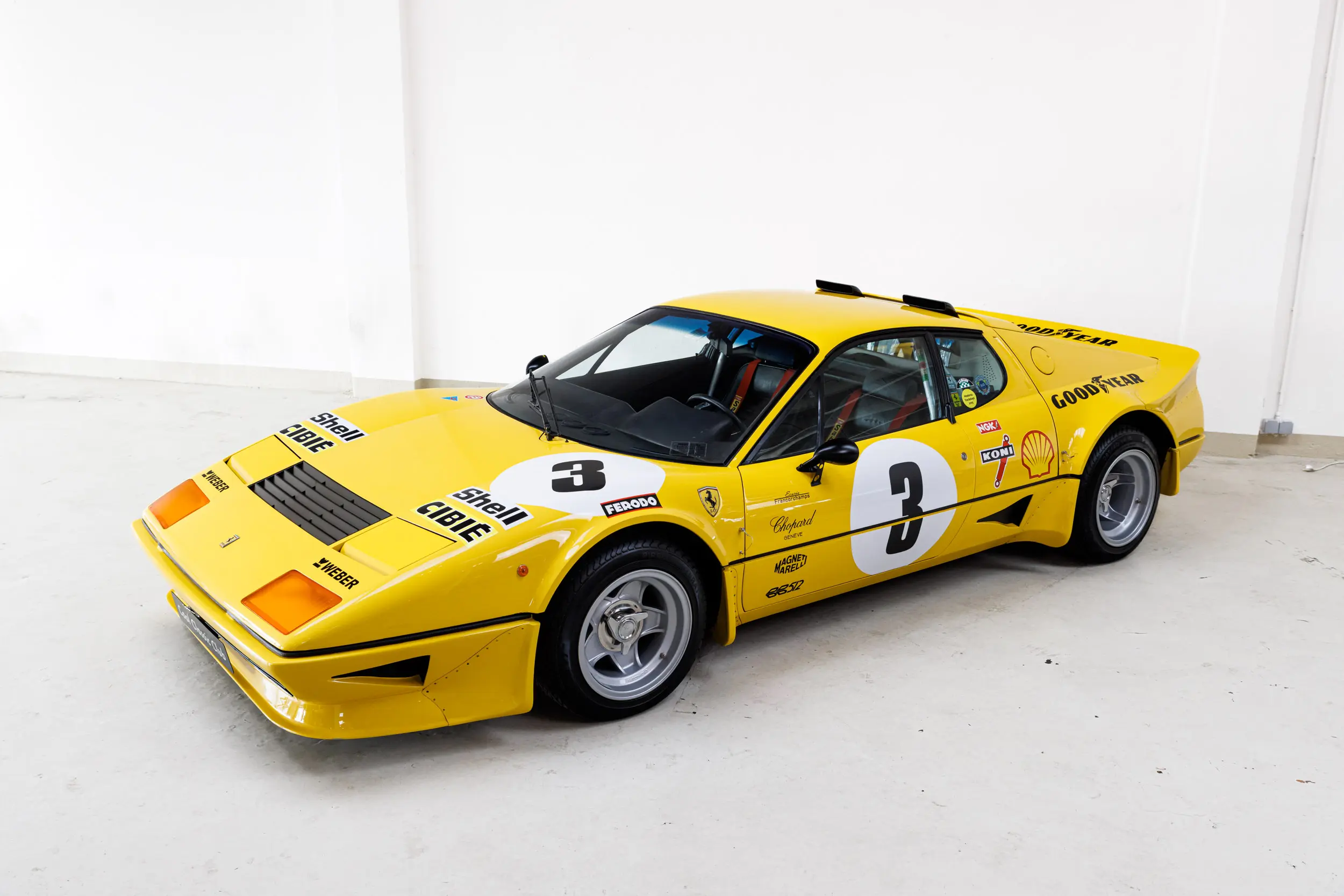 Front oblique view of the 1977 Giallo Modena Ferrari 512BB Competizione Stradale
