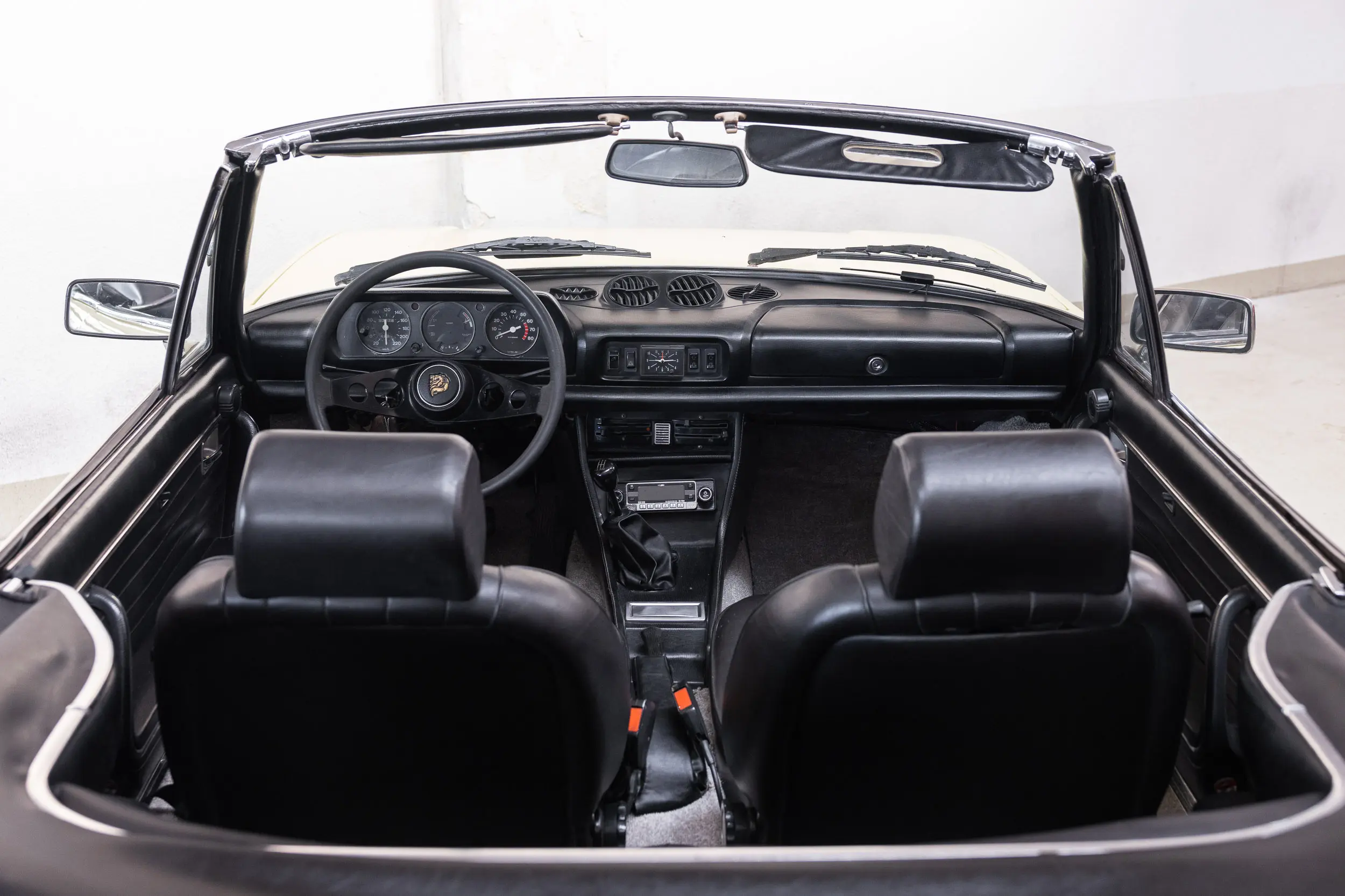 Overview of interior from rear of the 1975 Jaune Tullip Peugeot 504 Cabriolet 2.7 V6