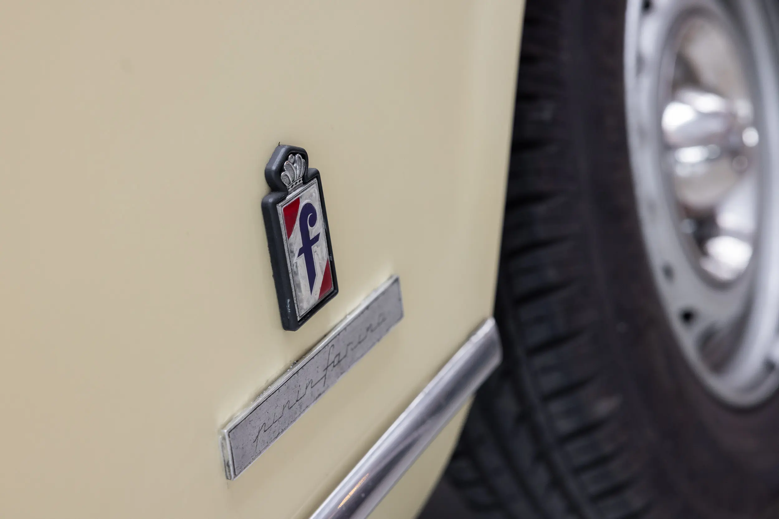 View of Pininfarina badge of the 1975 Jaune Tullip Peugeot 504 Cabriolet 2.7 V6
