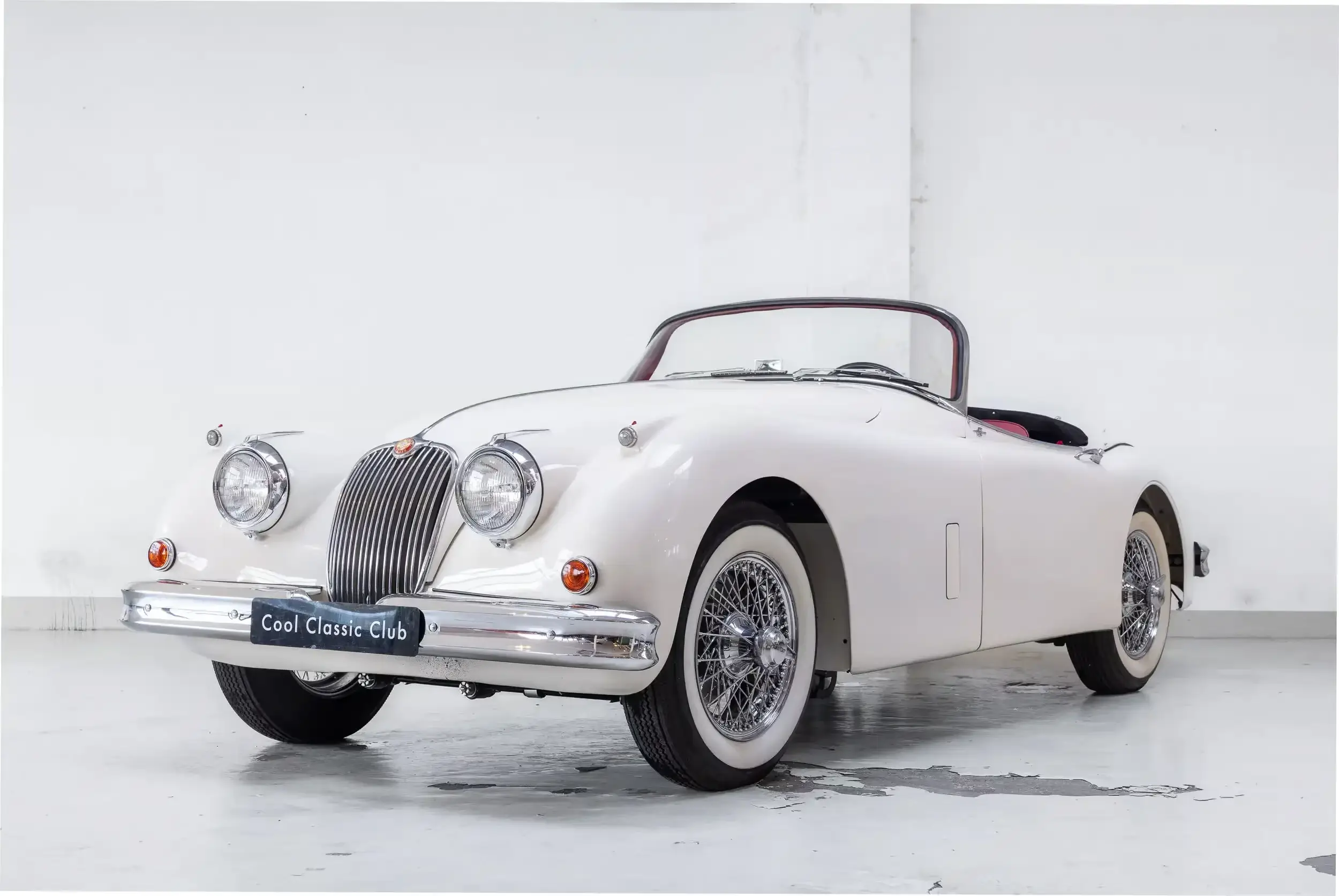 Front oblique view of the 1958 Cream Jaguar XK 150 S OTS