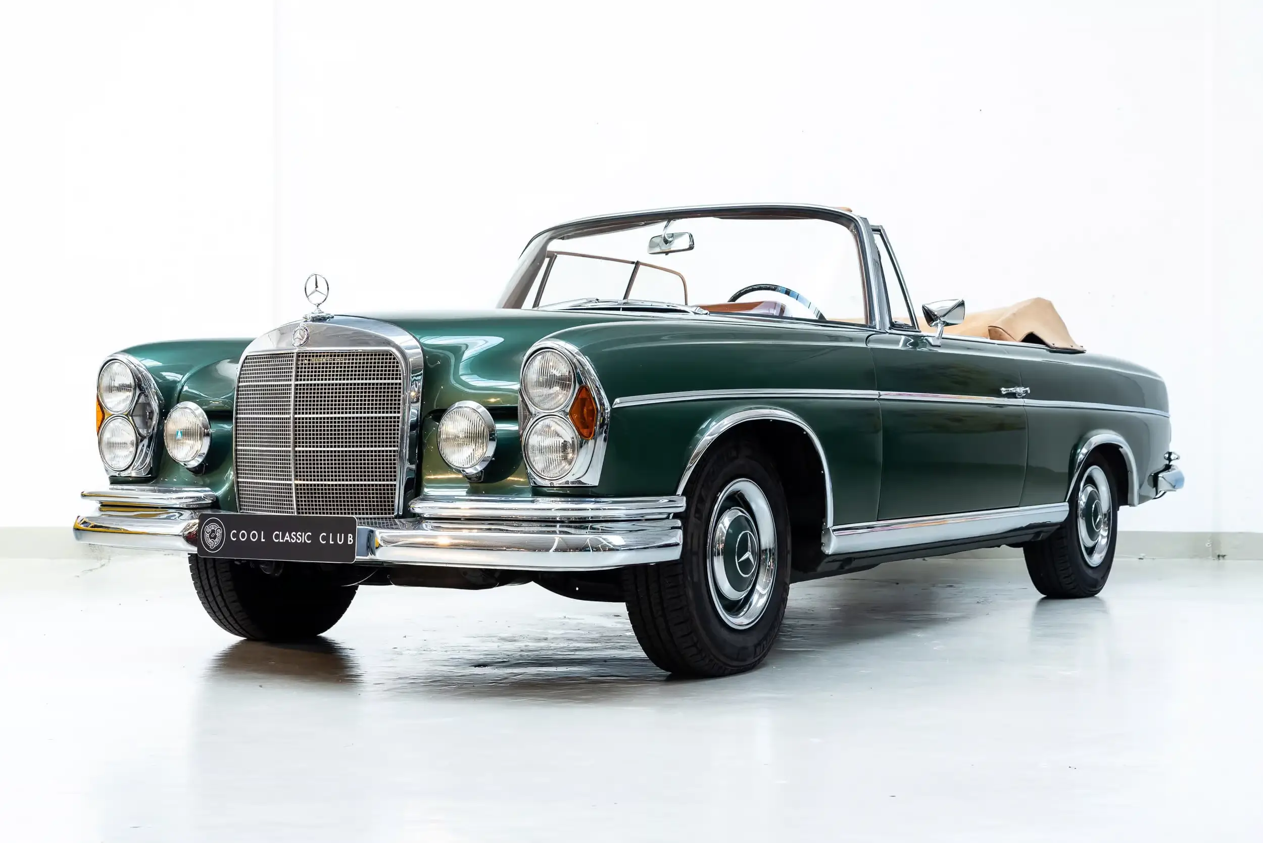 Front oblique view of the 1967 Moosgrün Metallic 834 Mercedes-Benz W112 300 SE Cabriolet
