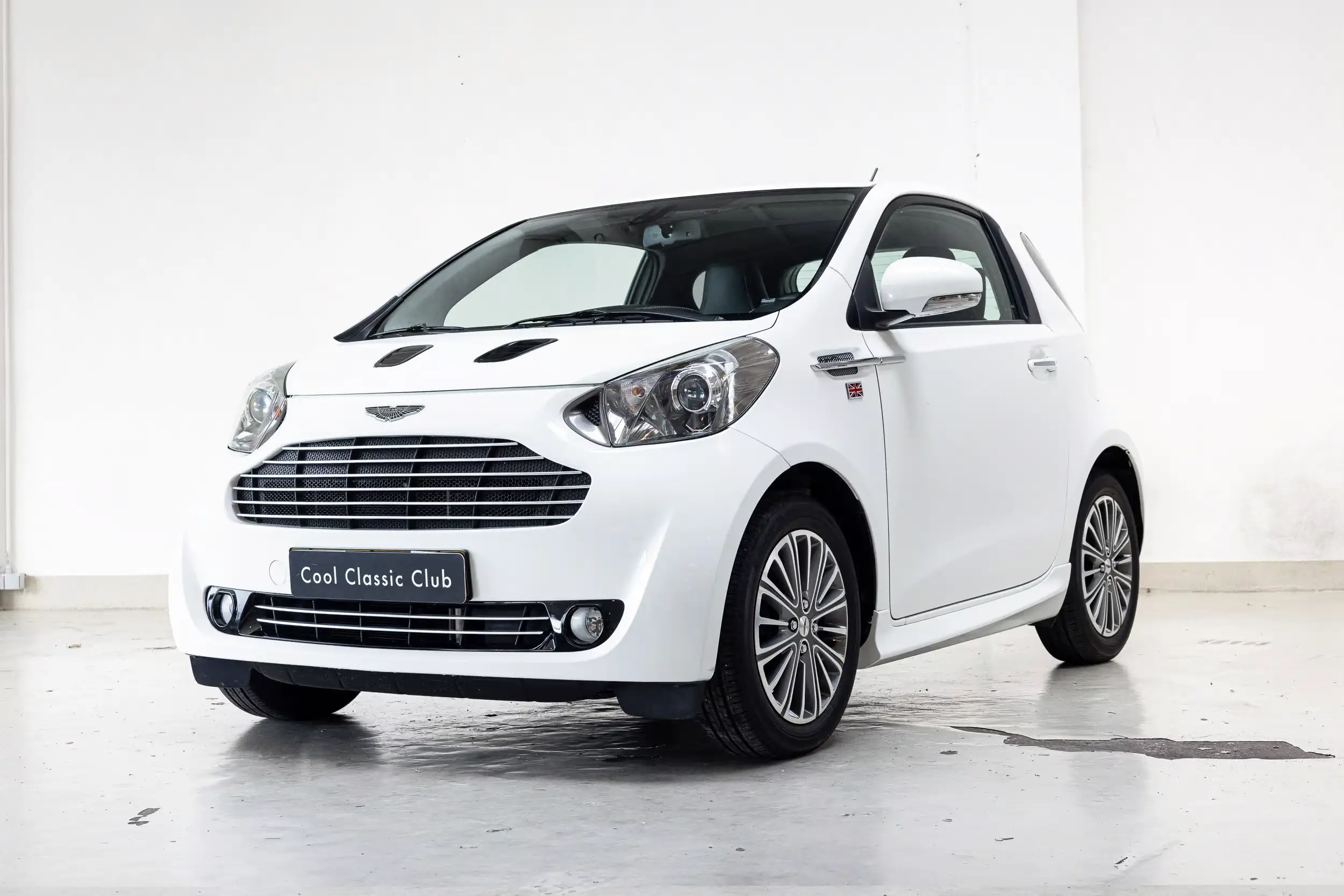 Front oblique view of the 2012 White Pearl Metallic Aston Martin Cygnet