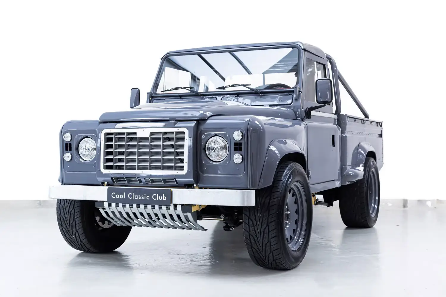 Front oblique view of the 1984  Porsche Slate Grey Land Rover Defender Pick-up Tophat
