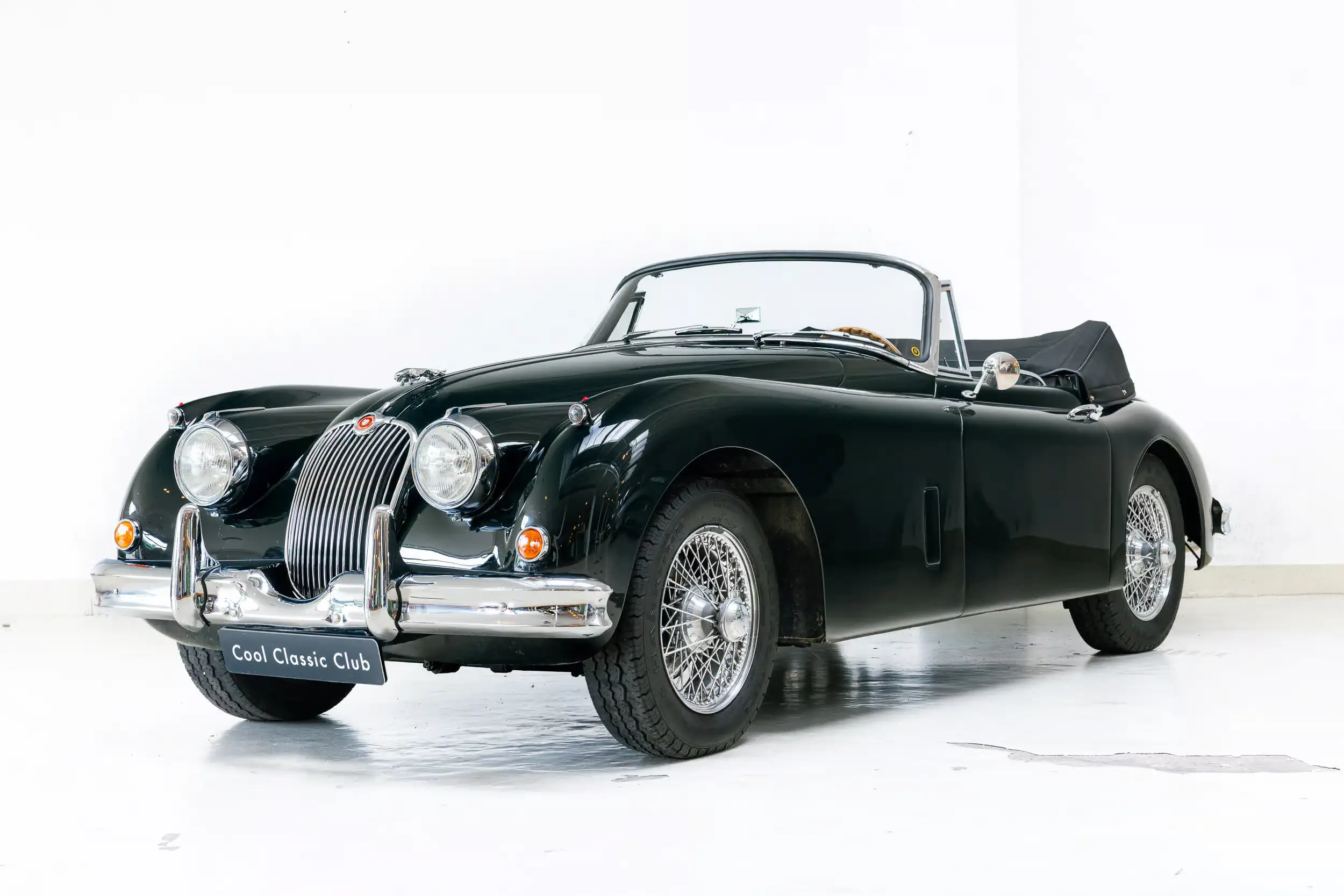Front oblique view of the 1960 British Racing Green Jaguar XK150 DHC