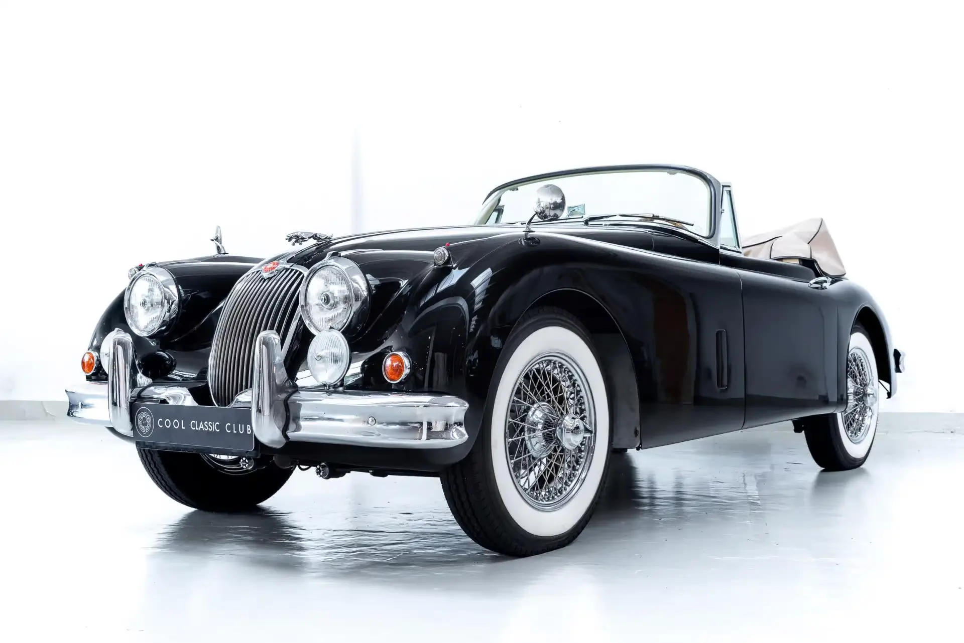 Front oblique view of the 1957 Black Jaguar XK150 DHC