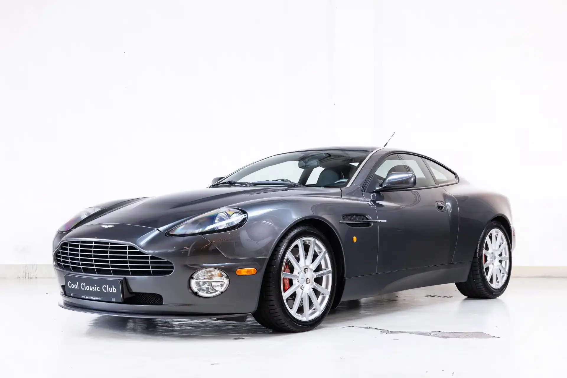 Front oblique view of the 2006 Meteorite Silver Metallic Aston Martin V12 Vanquish S