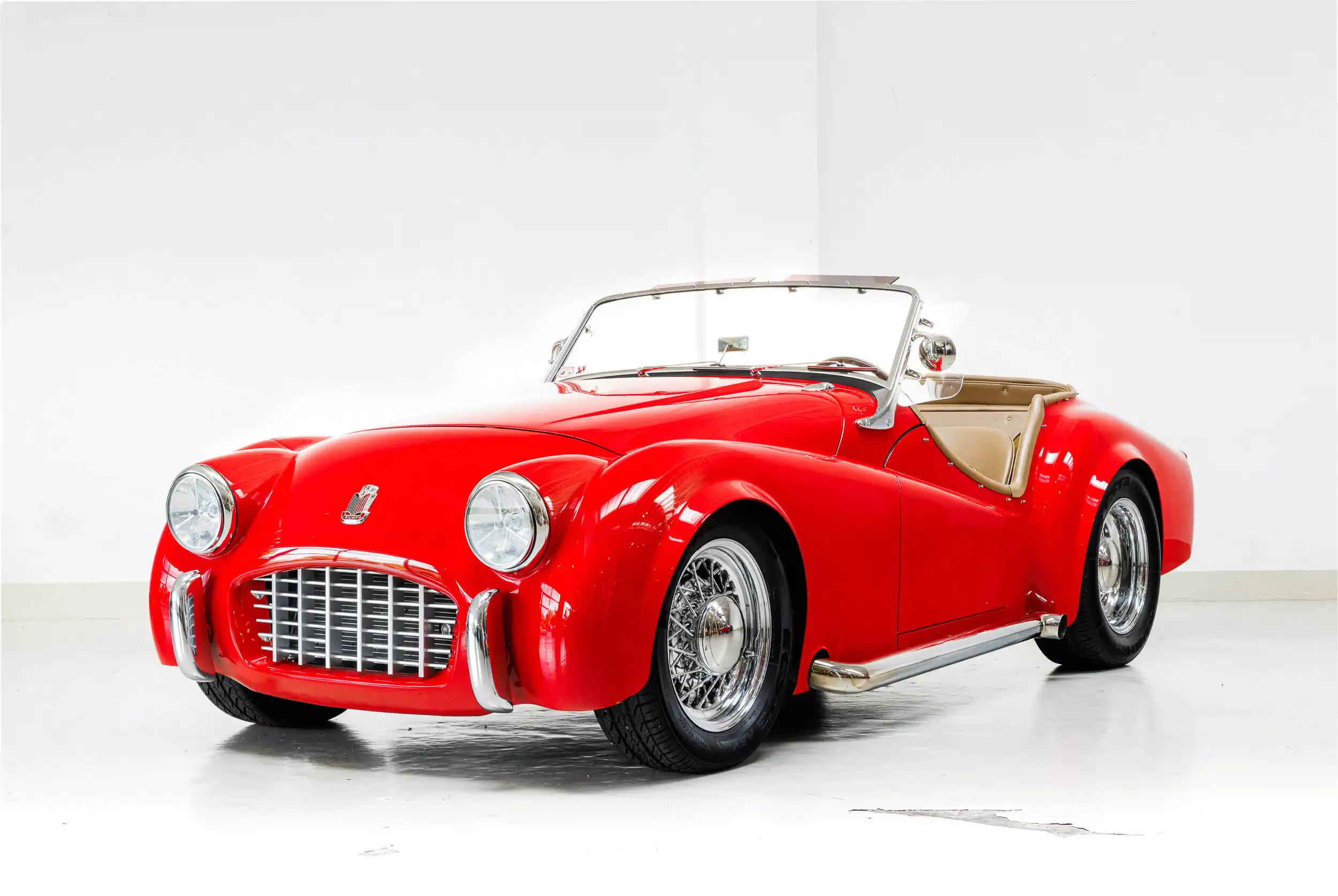 Front oblique view of the 1957 Pimento Red Triumph TR3 V8 Restomod