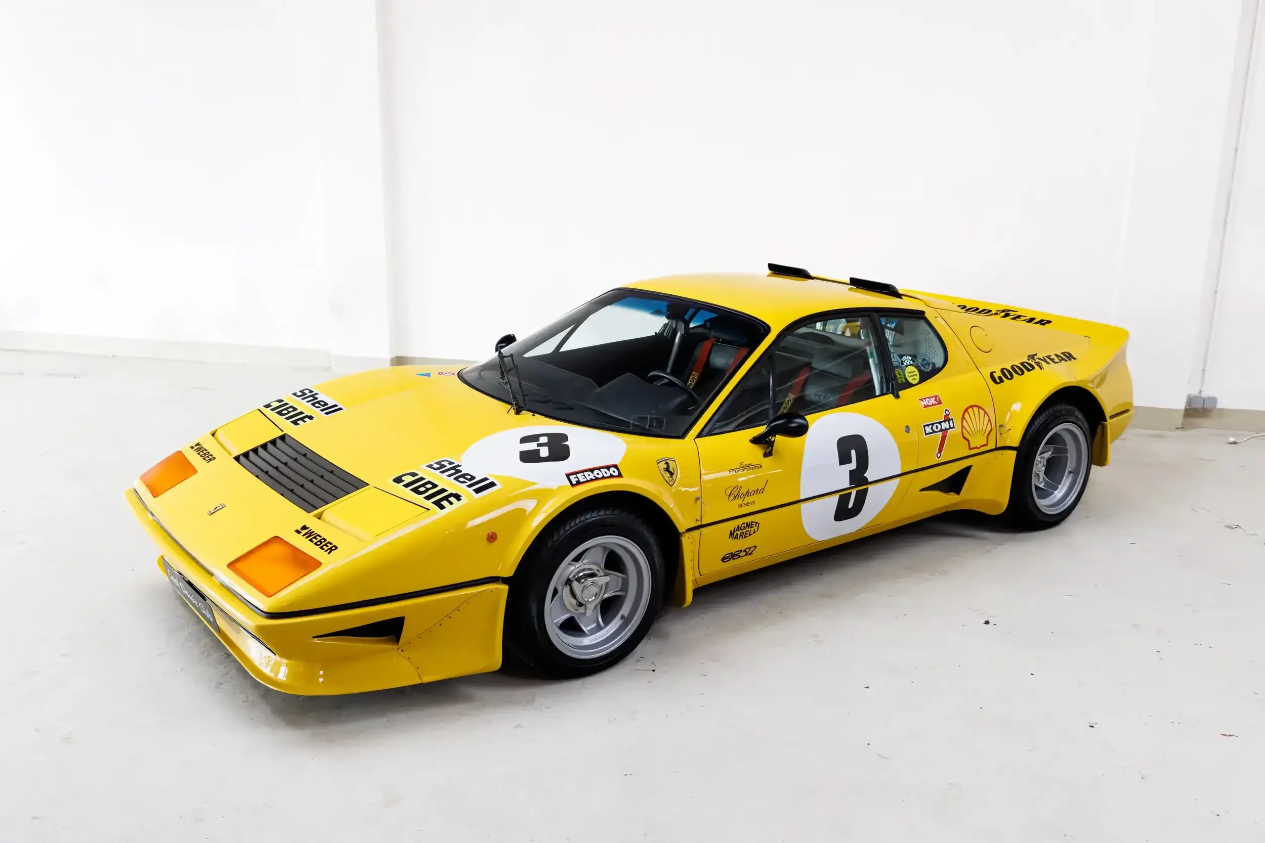 Front oblique view of the 1977 Giallo Modena Ferrari 512BB Competizione Stradale