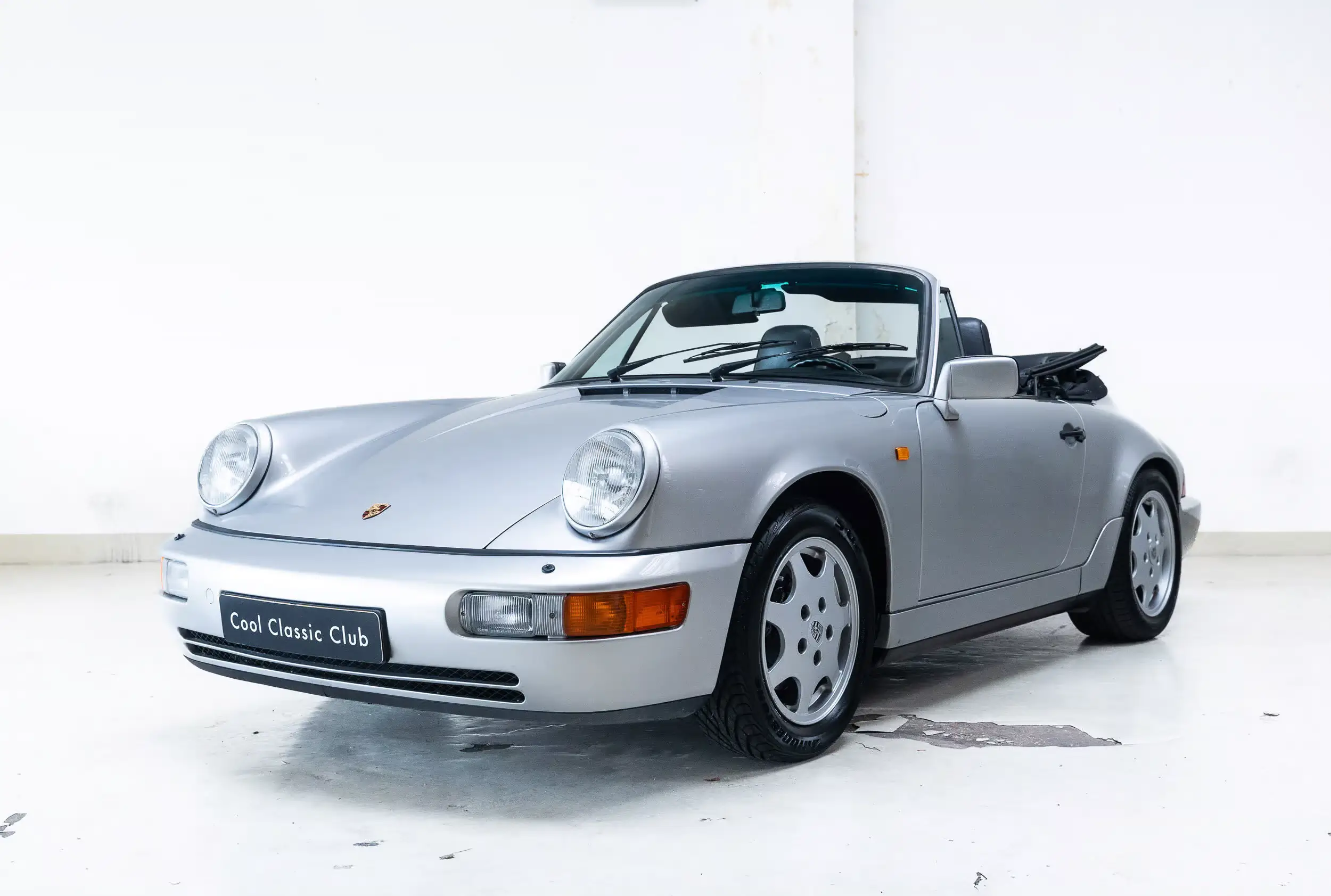 Front oblique view of the 1990 Artiksilber Porsche 964 Carrera 2 Cabriolet