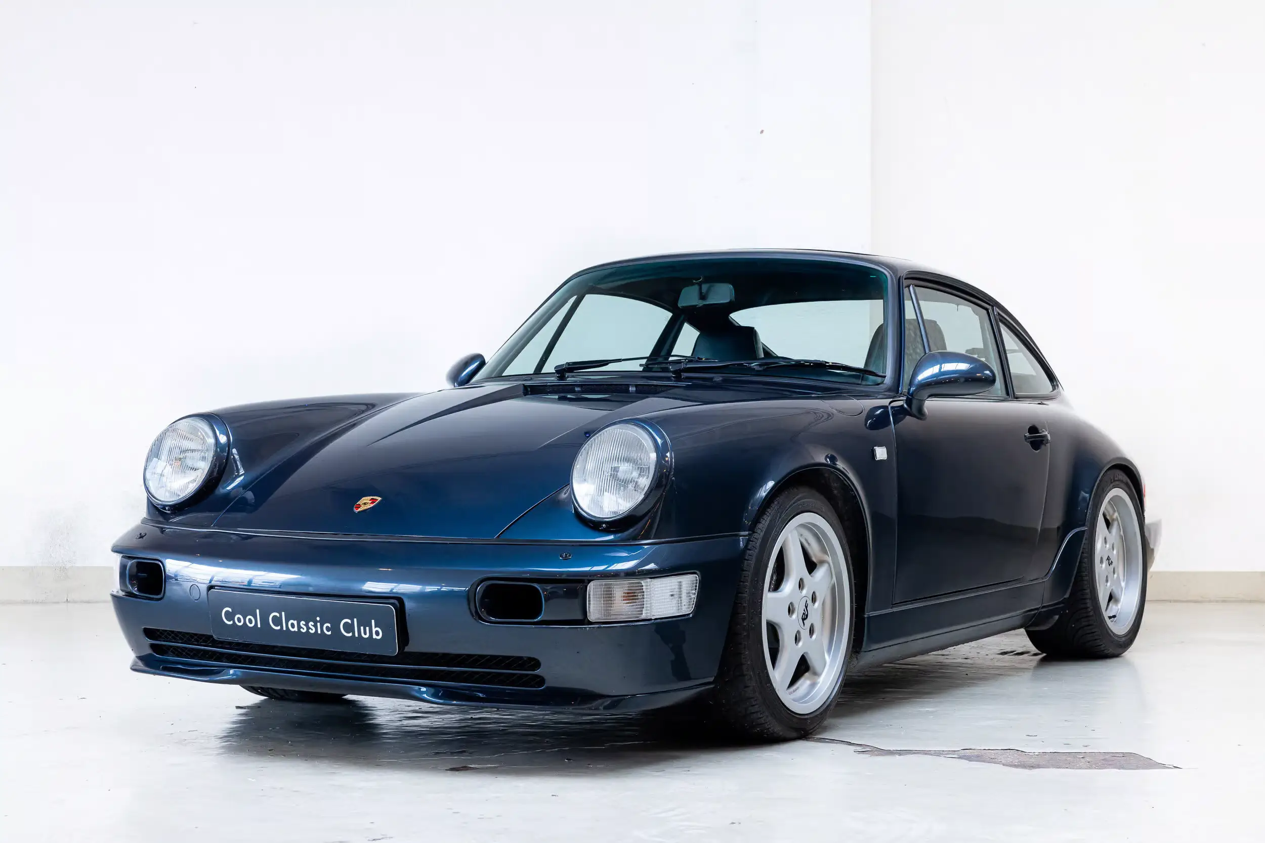 Front oblique view of the 1989  Marine Blue metallic Porsche 964 Carrera 2 