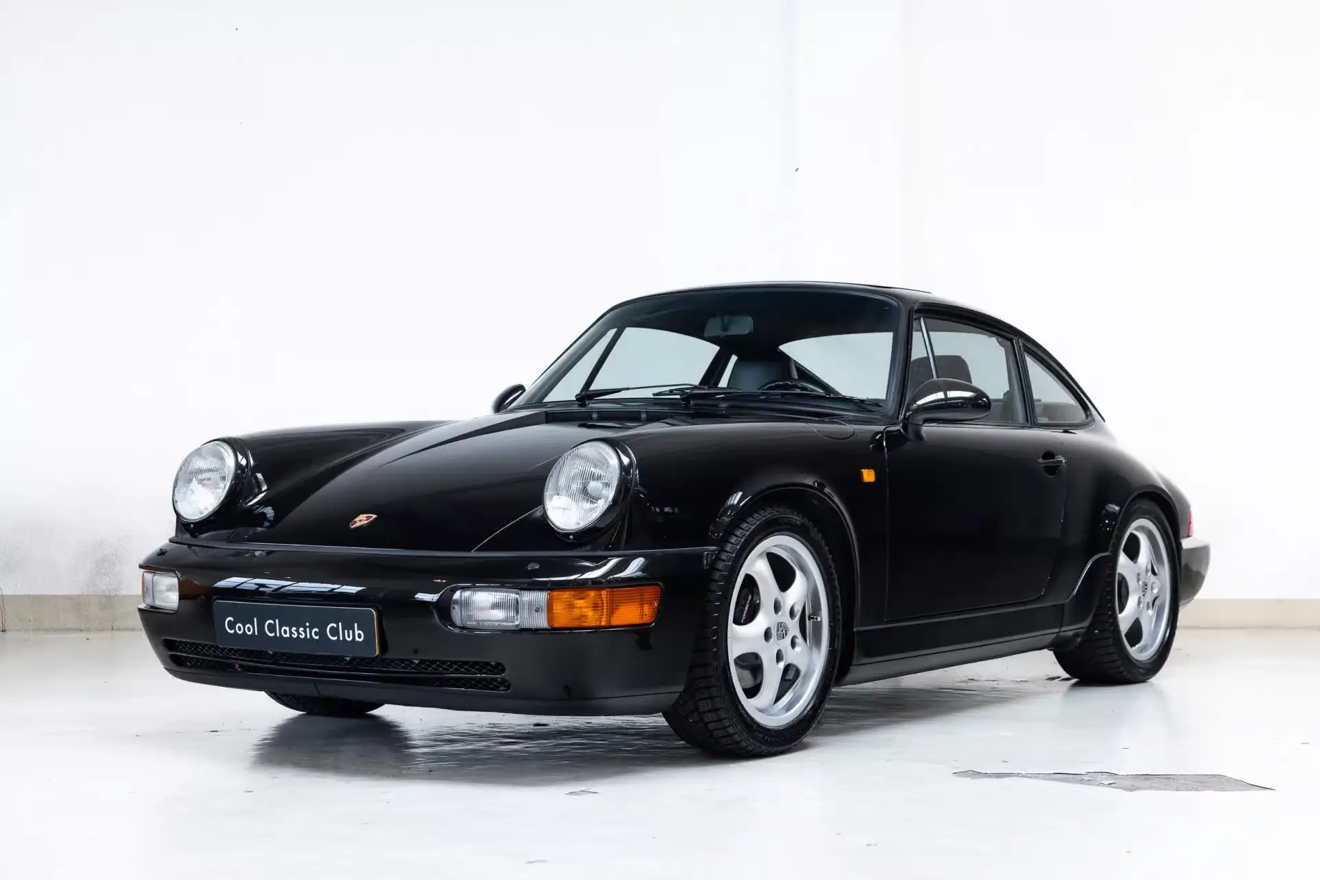 Front oblique view of the 1991 Black Pearl Porsche 964 Carrera 2
