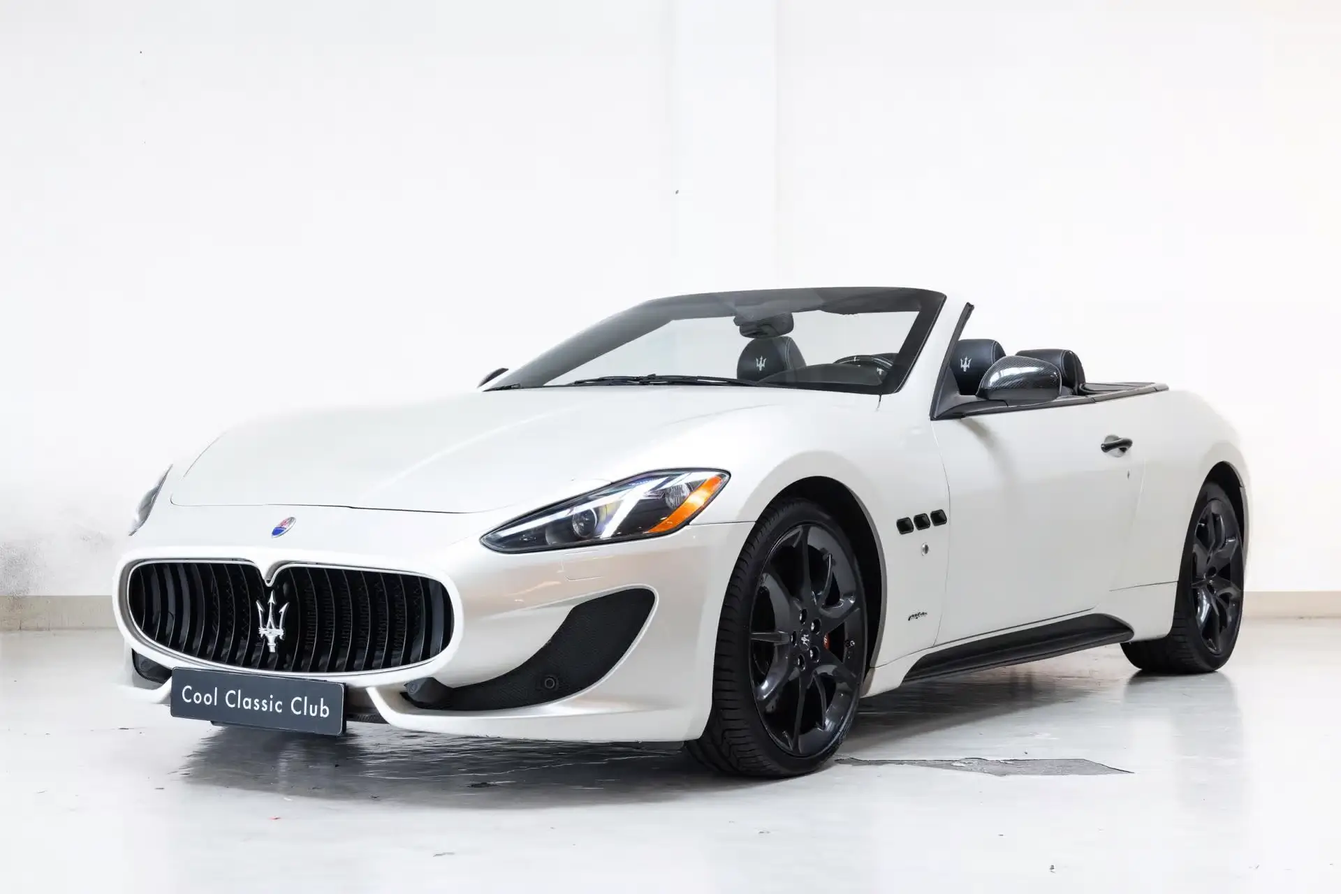 Front oblique view of the 2012 Bianco Fuji Maserati GranCabrio 4.7