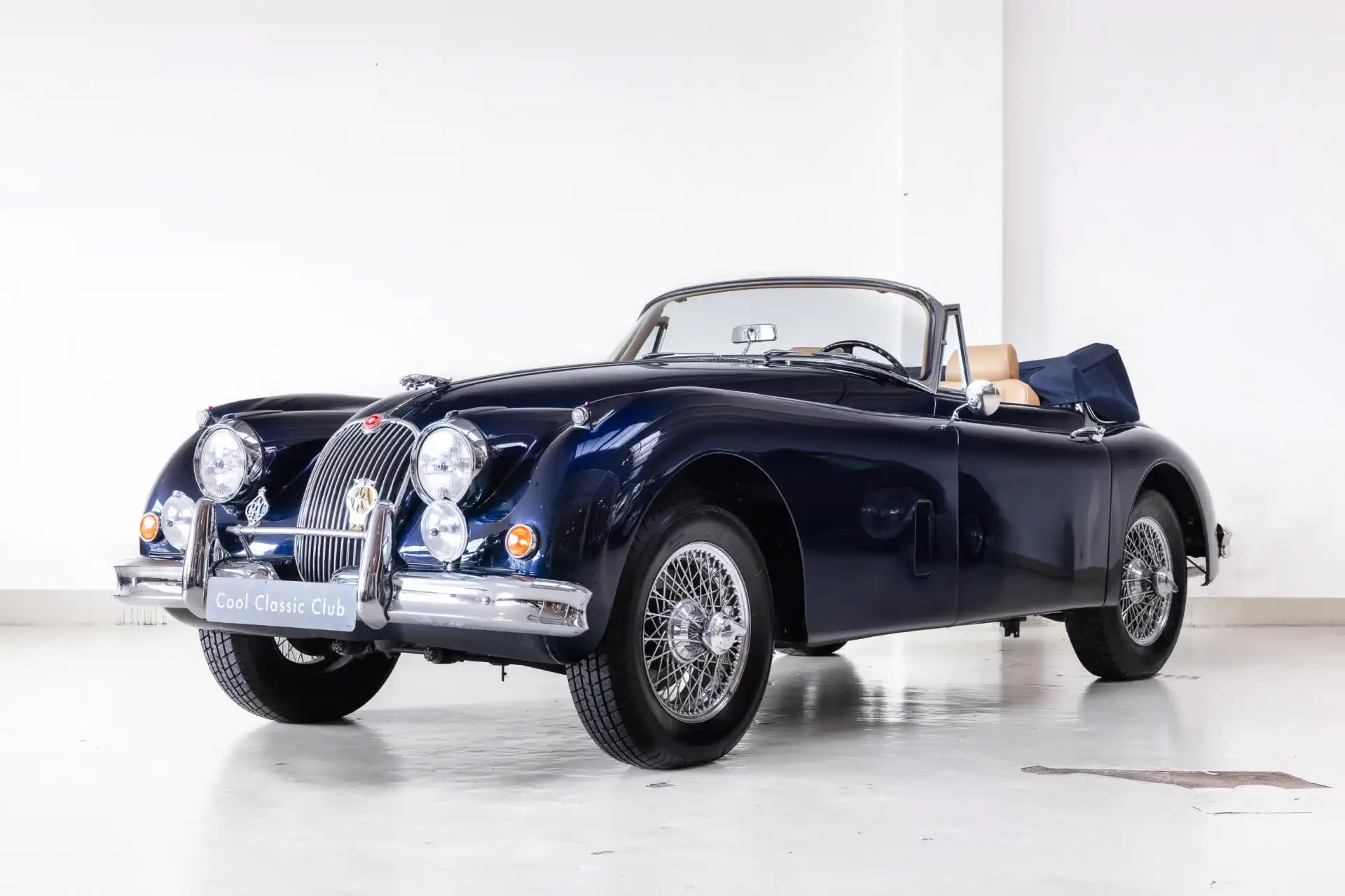 Front oblique view of the 1958 Indigo Blue Jaguar XK150 3.4 DHC