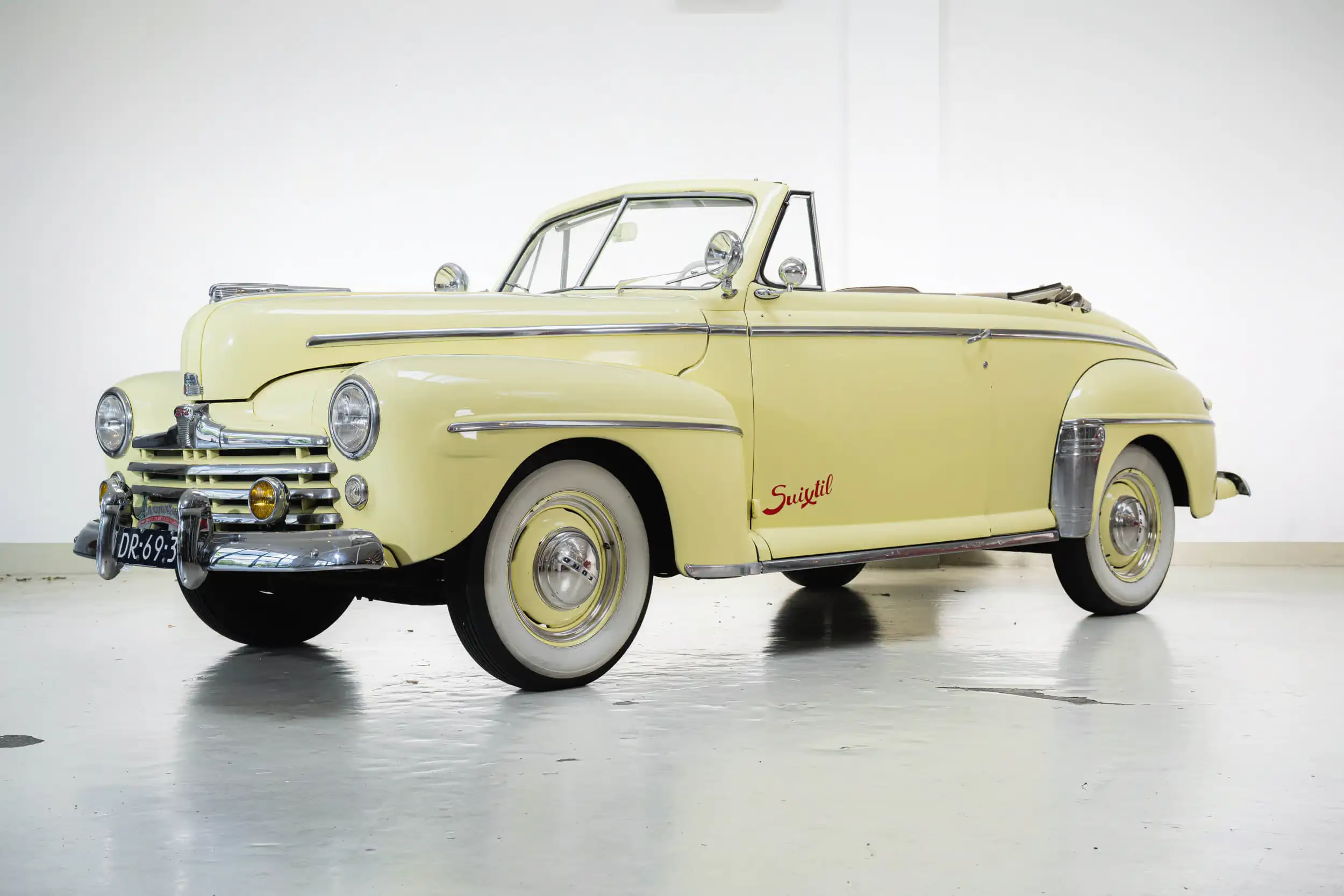 Front oblique view of the 1947 Maize Yellow Ford Super Deluxe V8