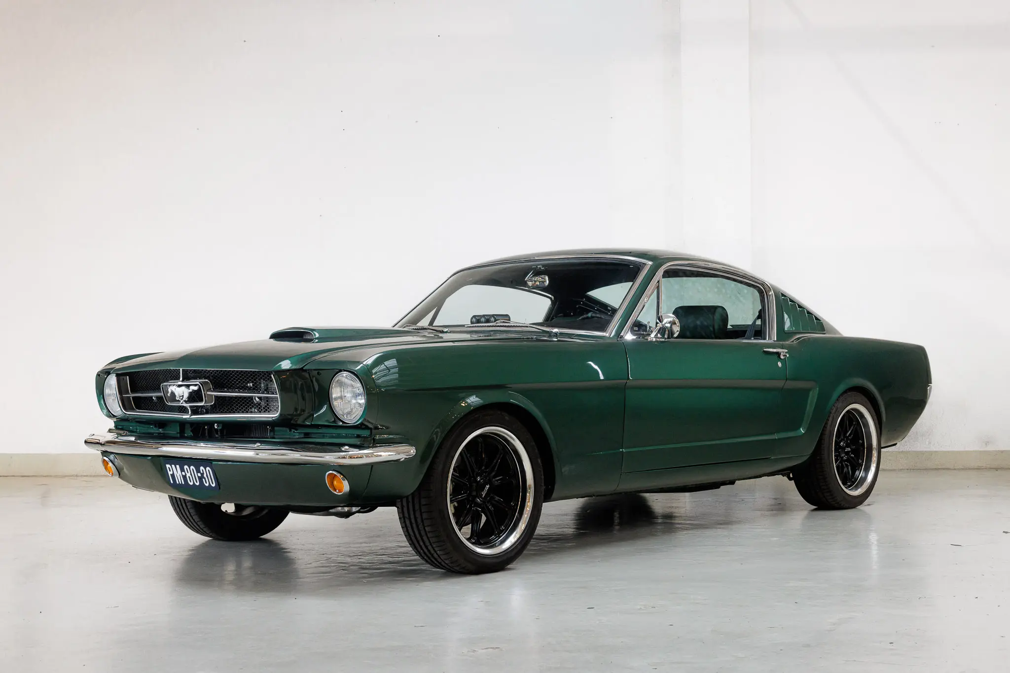 Front oblique view of the 1965 Buckinghamshire Green Metallic Ford Mustang Fastback Restomod