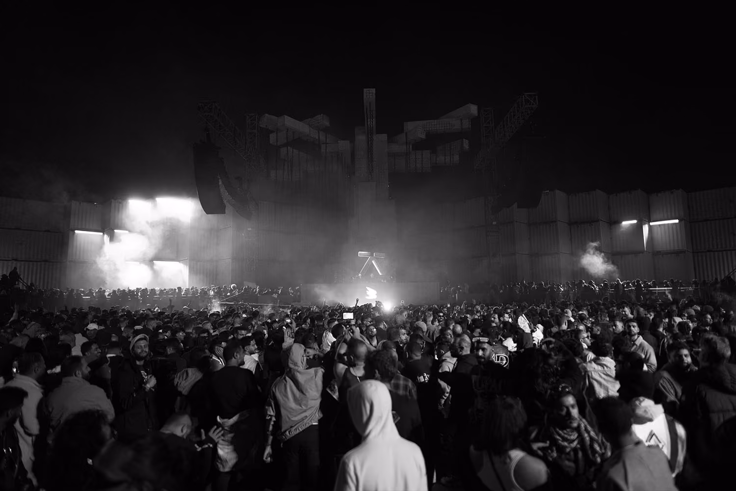 A bustling nighttime concert crowd at MDLBeast Soundstorm, with a prominent Cohesion PA system delivering powerful sound.