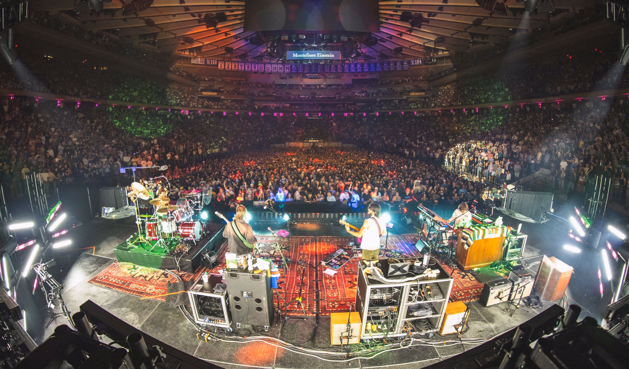 A wide shot from behind of Goose on stage playing to a sold out crowd at Madison Square Garden