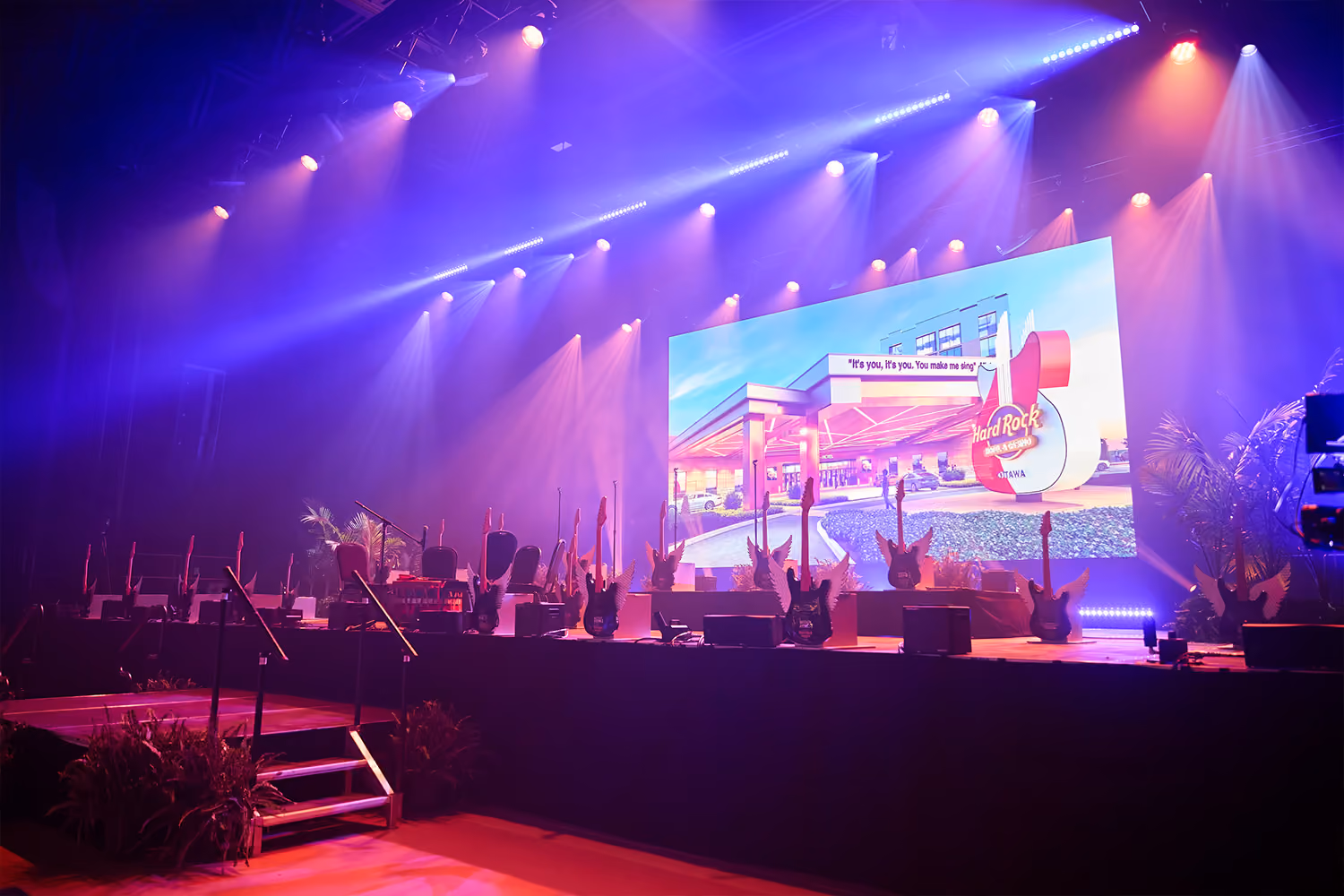 A stage with blue and pink lighting at Hard Rock Ottawa opening
