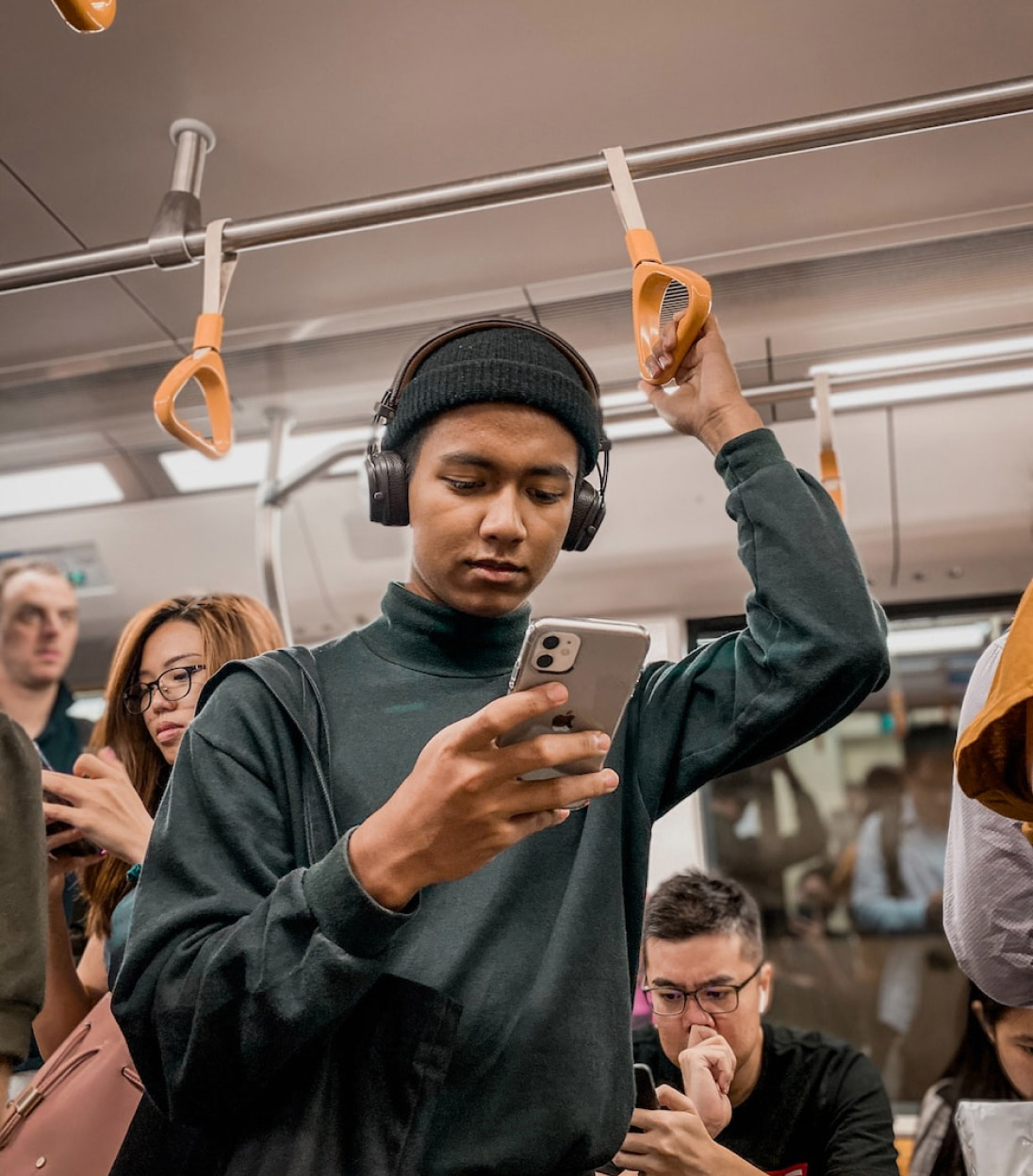 Young man on subway looking at phone