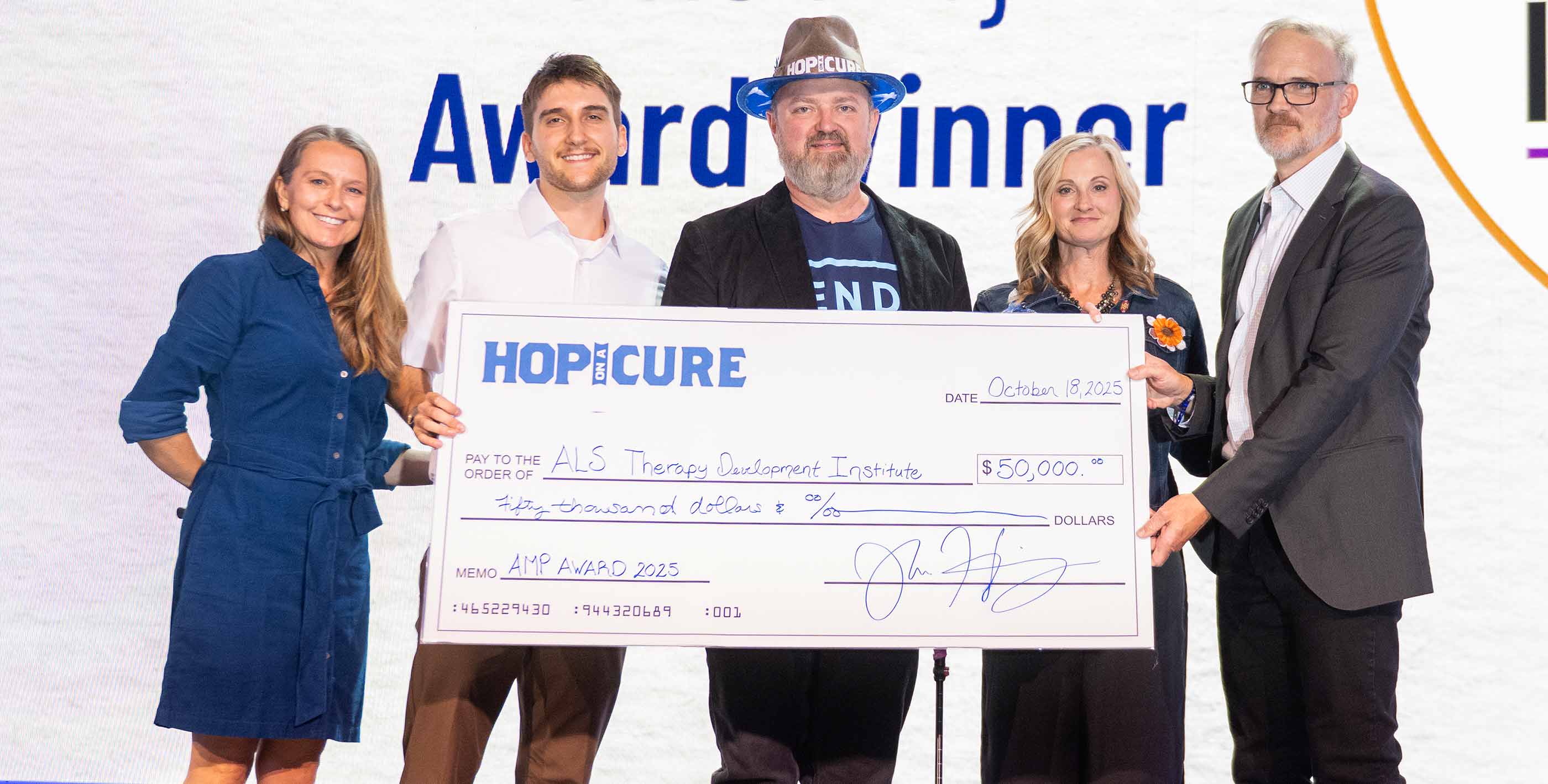 Hop On A Cure Team -Accepting donation check on stage