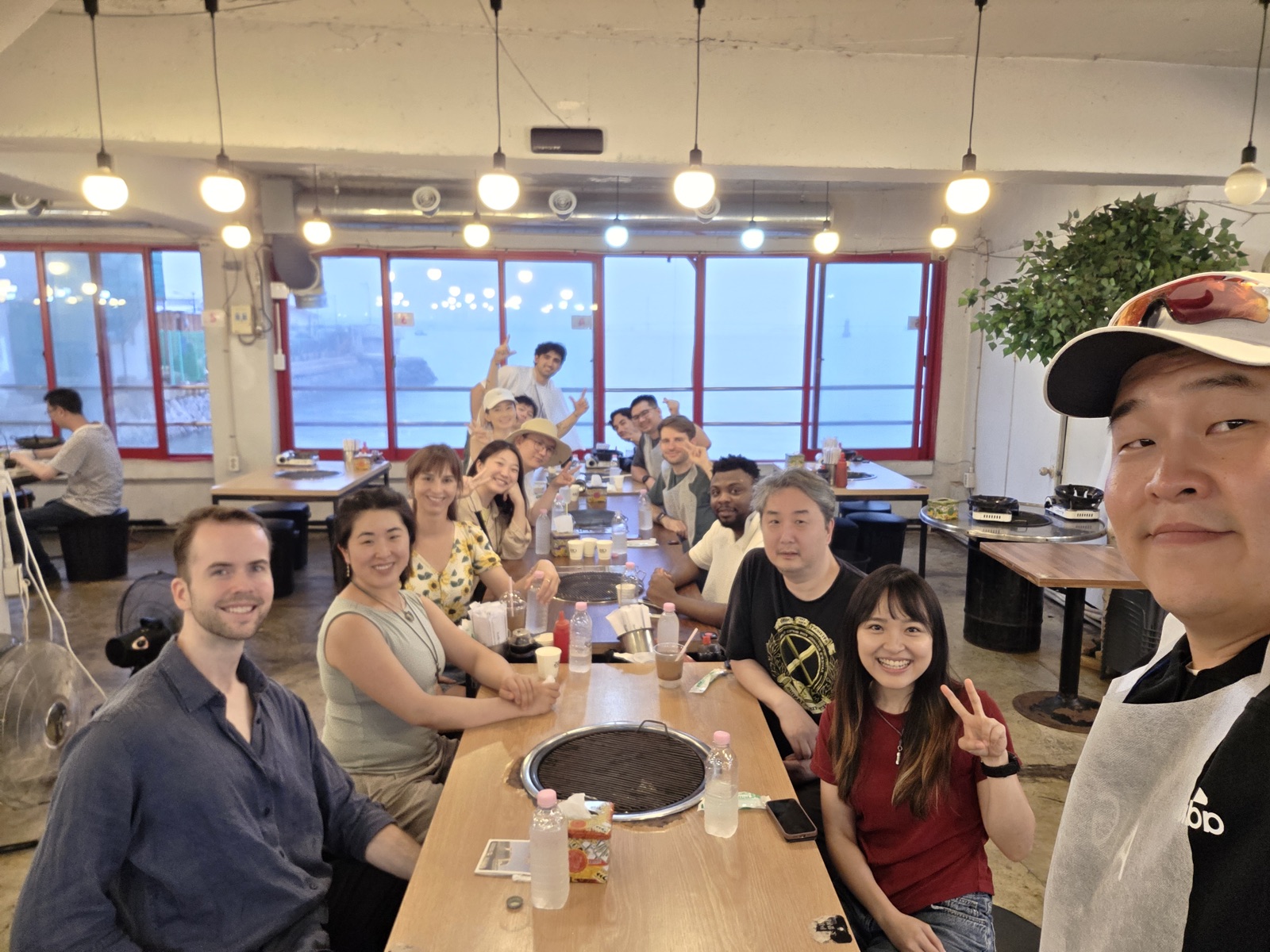 Incheon Summer Workation participants gathered around a long dinner table