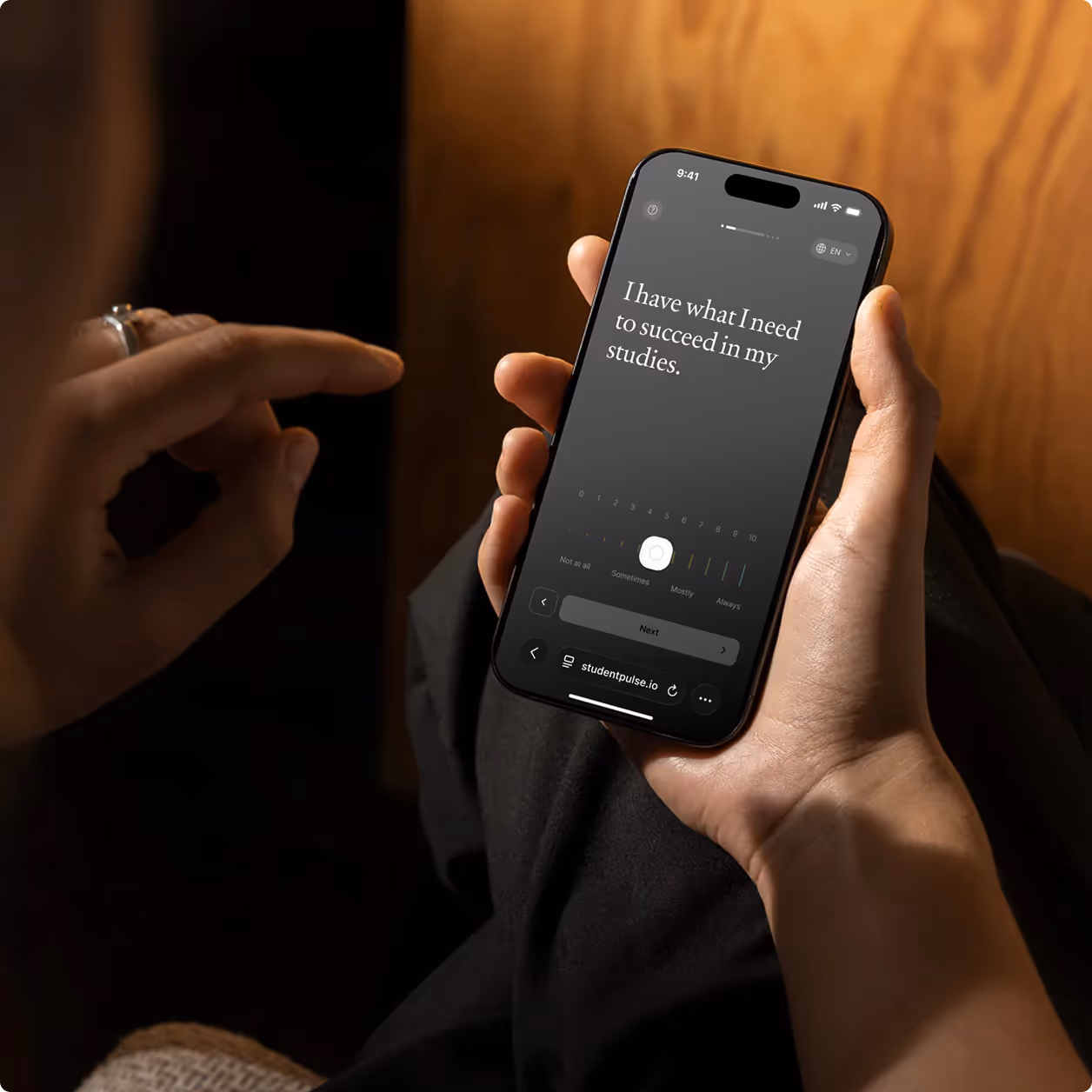 Hands typing on a MacBook Pro keyboard with a web app displaying a checklist and timeline on the screen.