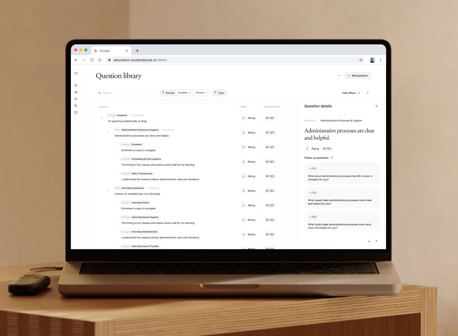 Laptop screen showing a question library interface with academic and internship topics and ratings.