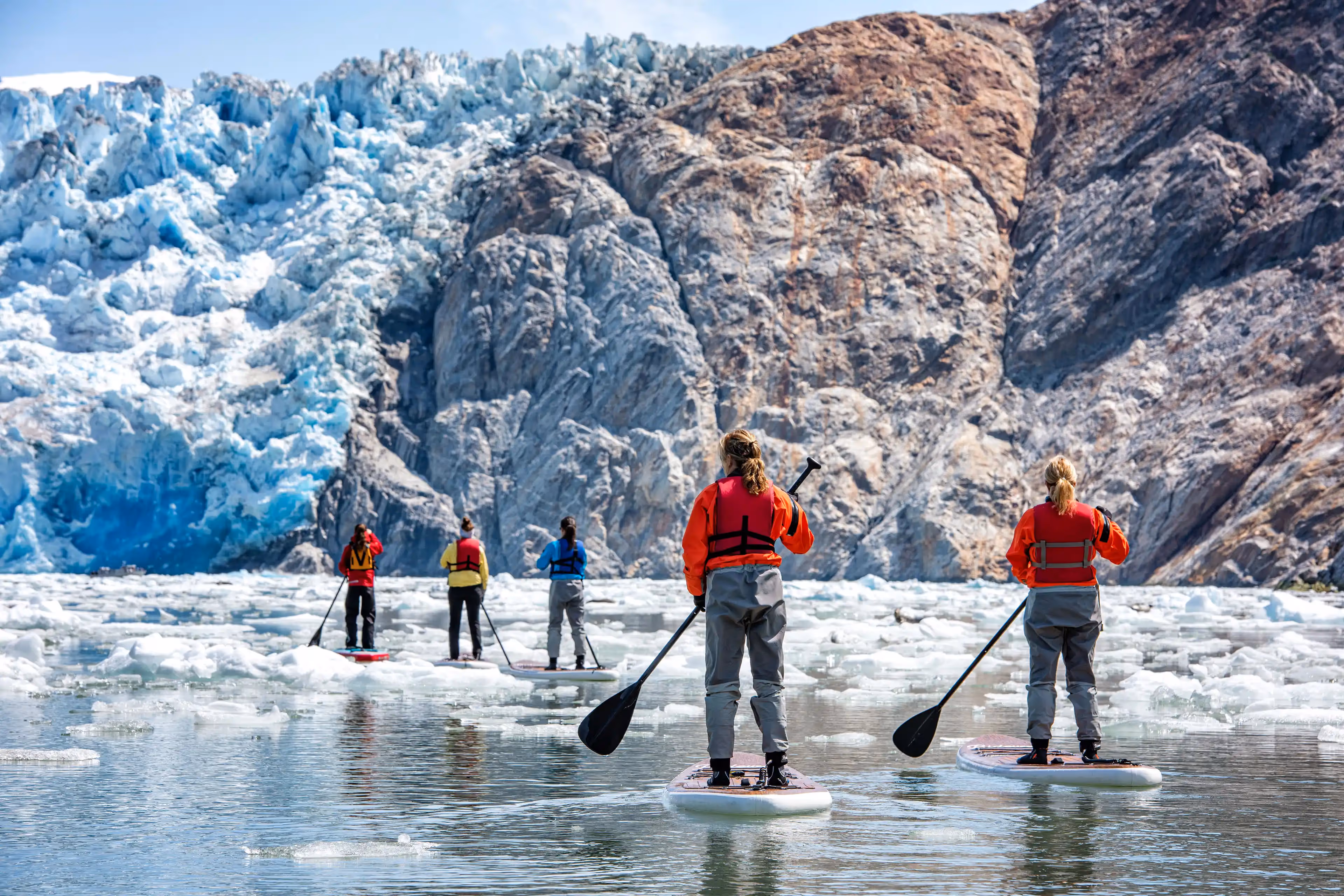 Stunning views of paddlers in Tracy Arm, featuring glaciers and emerald waters.