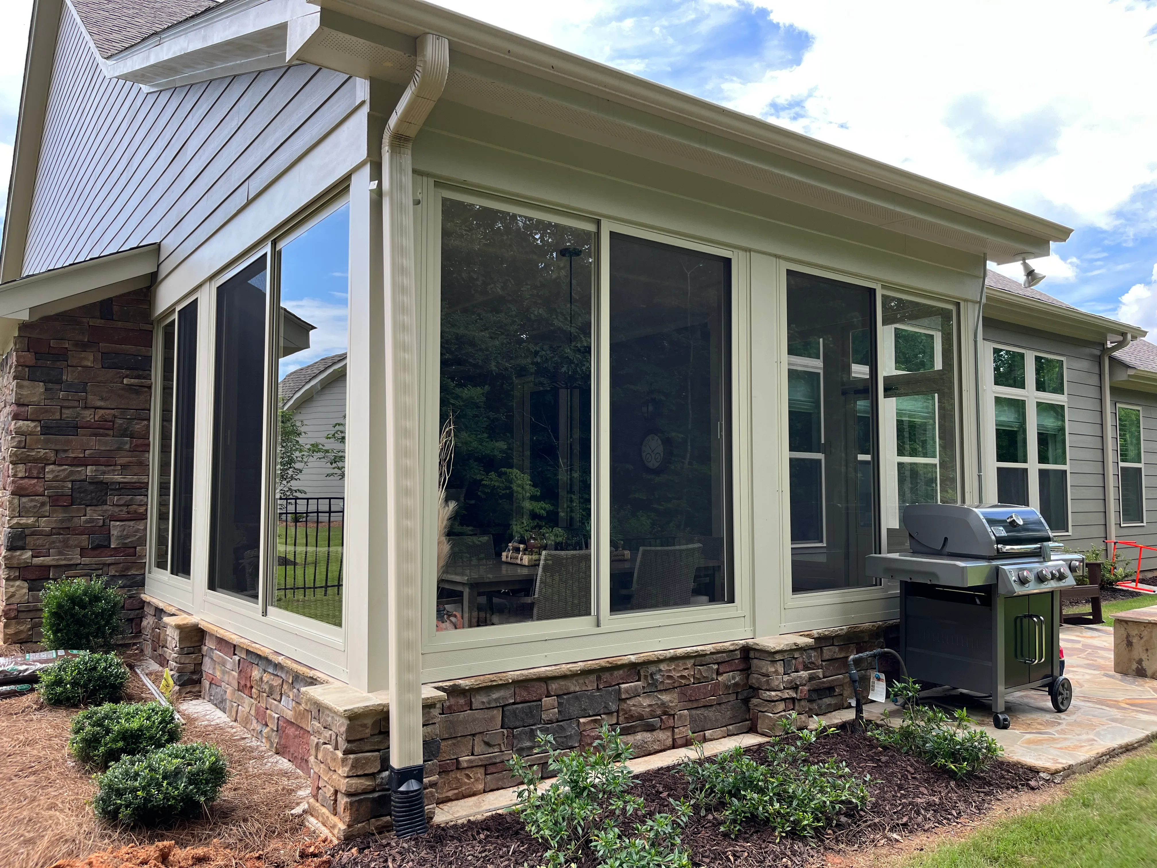 A custom glass window sunroom addition built in a brick based home in North Georgia