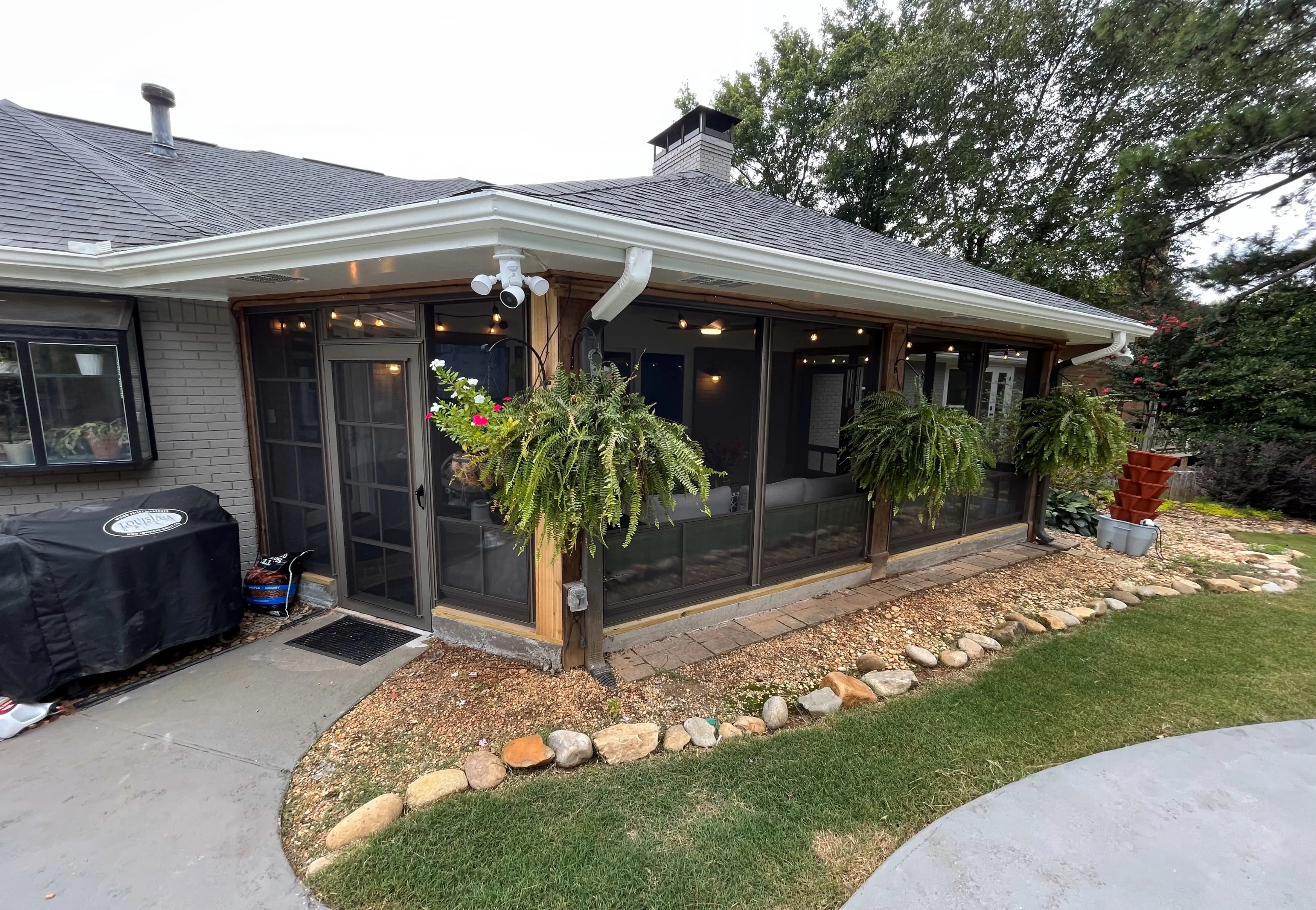The inside of a spacious custom sunroom addition built on the back of a North Georgia home in the woods with a custom wood deck outside