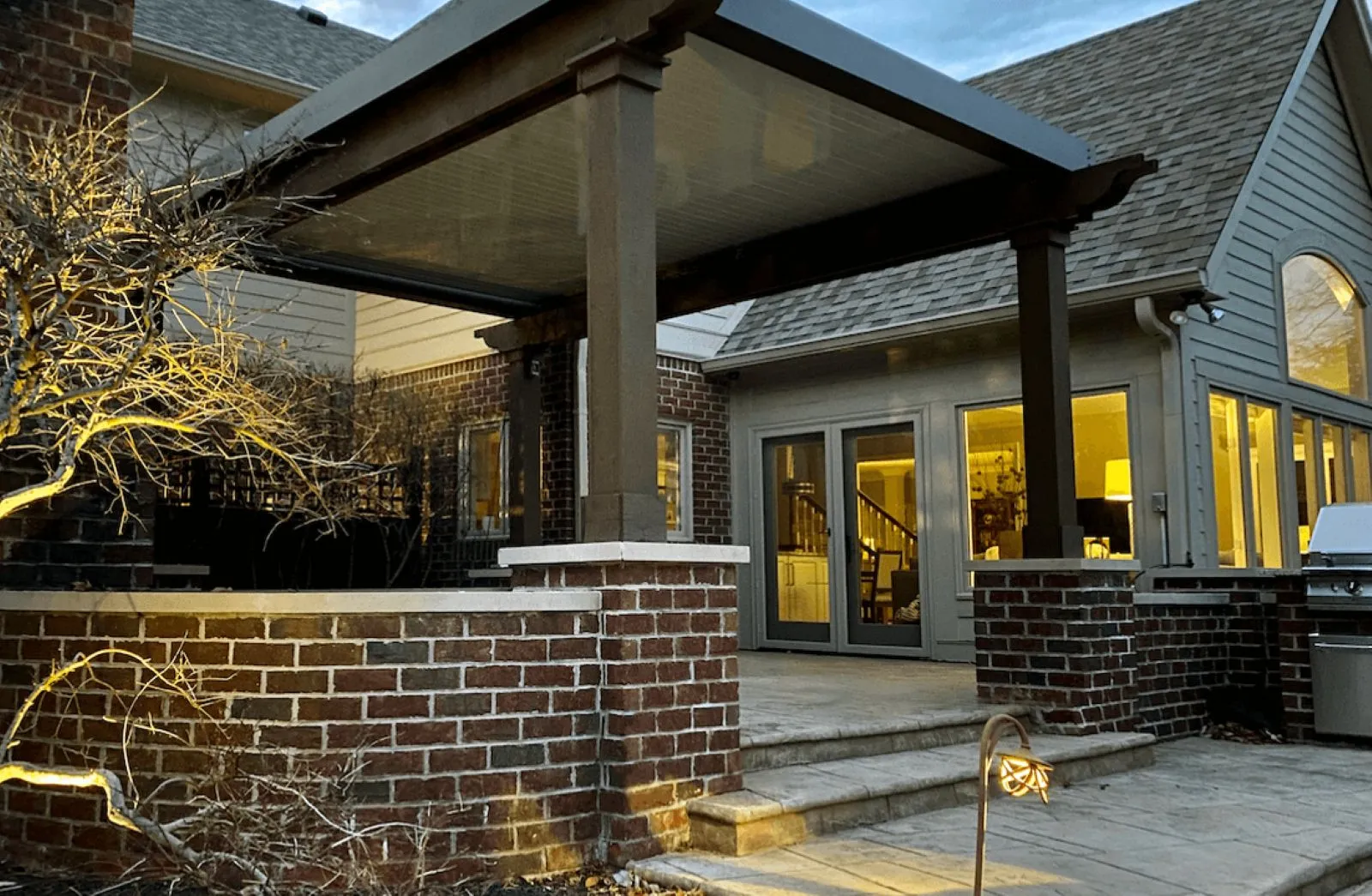 A beautiful custom outdoor pergola structure made of wood installed within open space surrounded by trees and plants in North Georgia