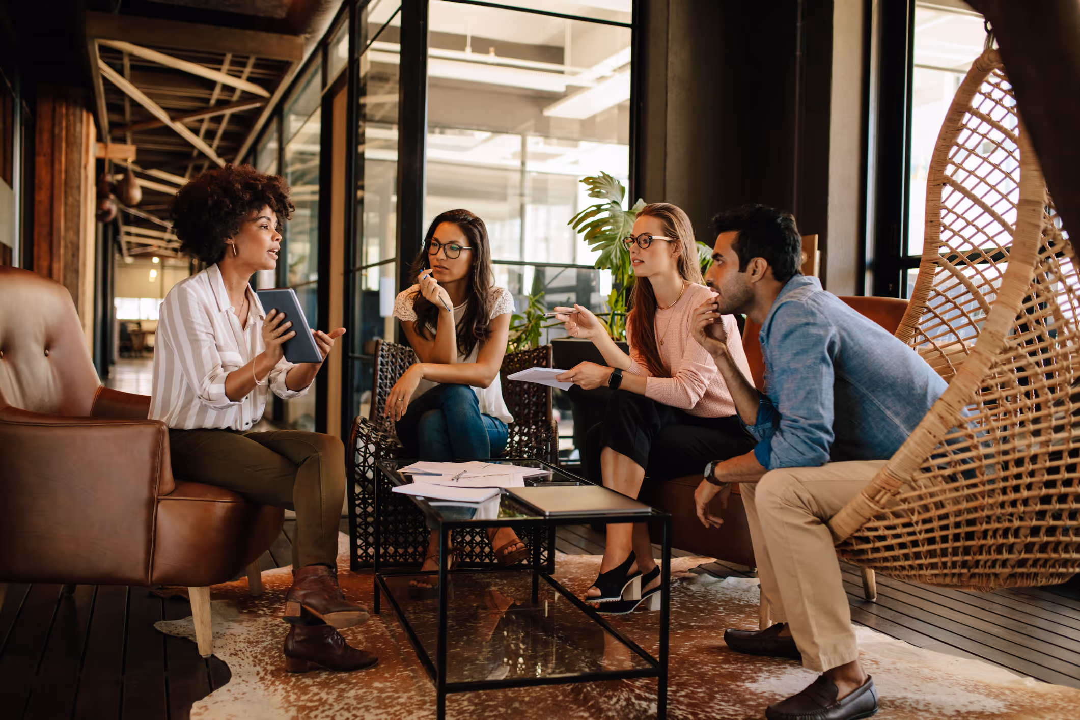 Group of people seating around lounge area having meaningful conversation
