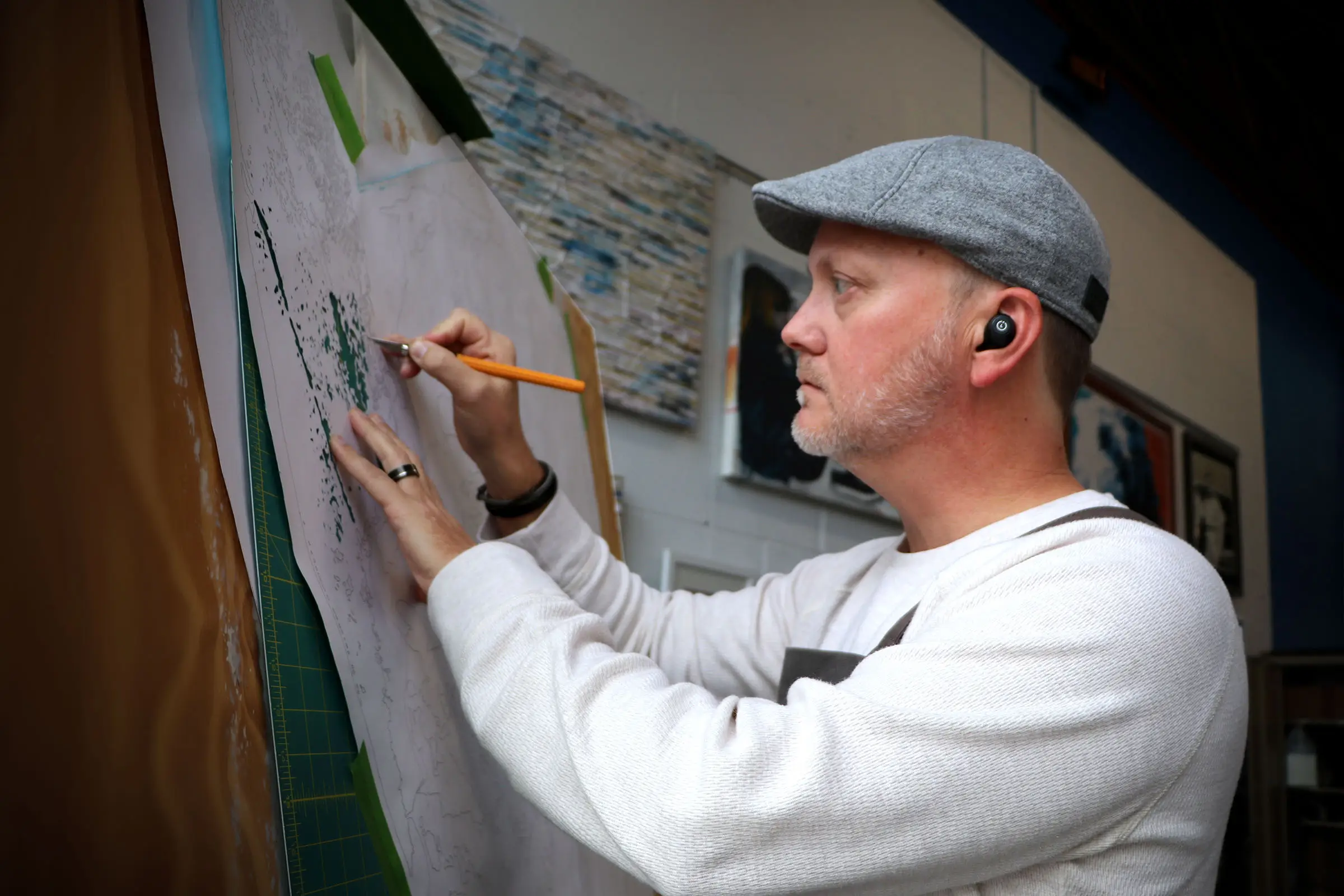 BJ in the process of hand-cutting his artwork.