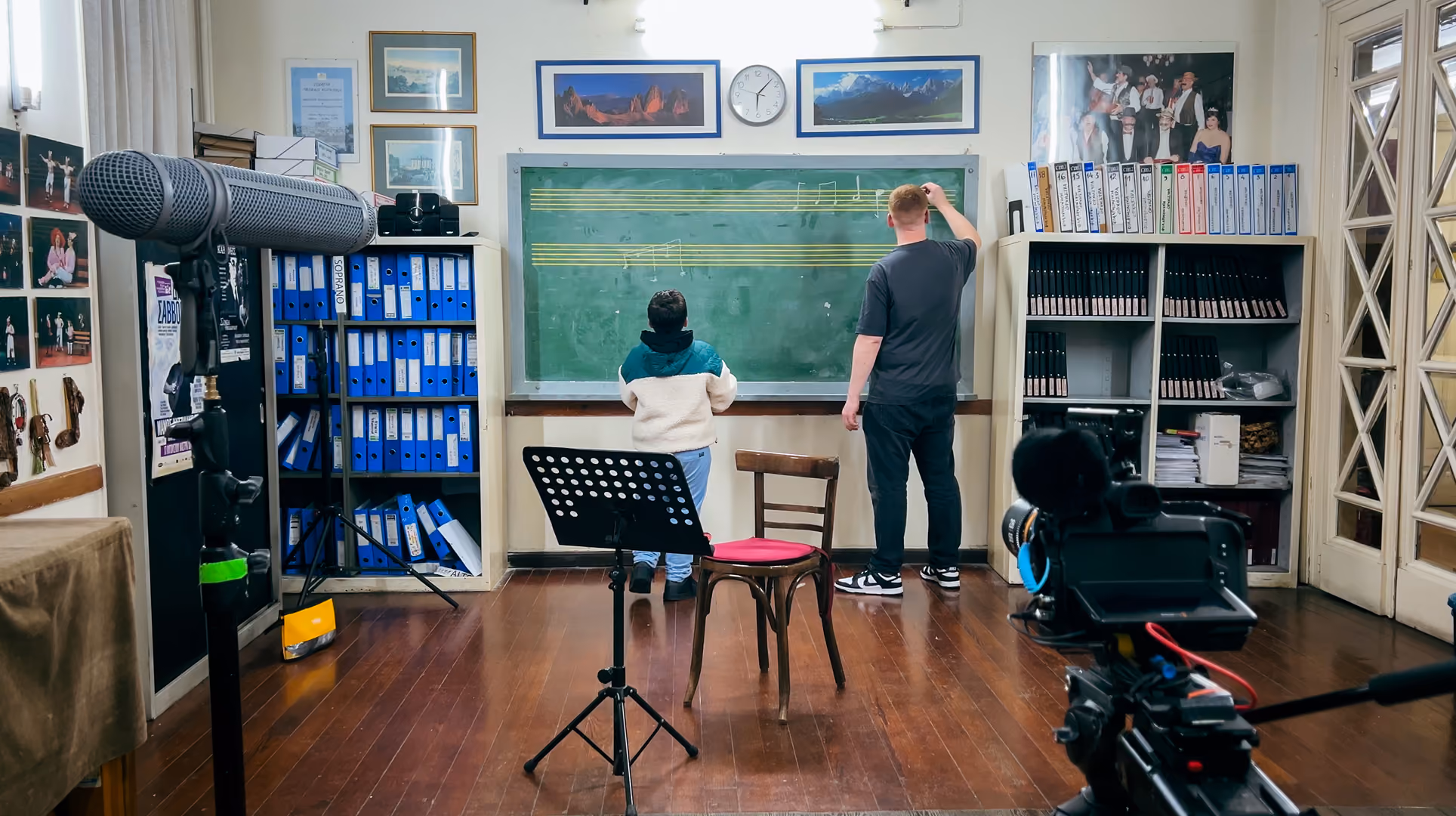 Behind-the-scenes shot of a Paragon Pictures crew filming a lesson at a chalkboard, from a Yamaha production