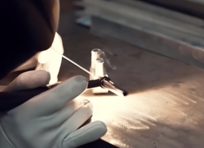 An Aston Martin engineer rebuilding an Aston Martin engine.