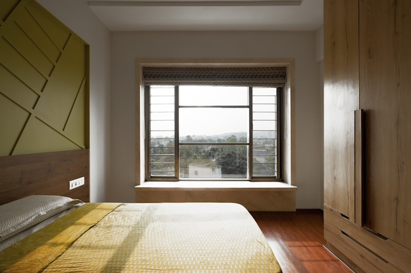 Bright modern Singapore bedroom with a large open window letting in soft daylight