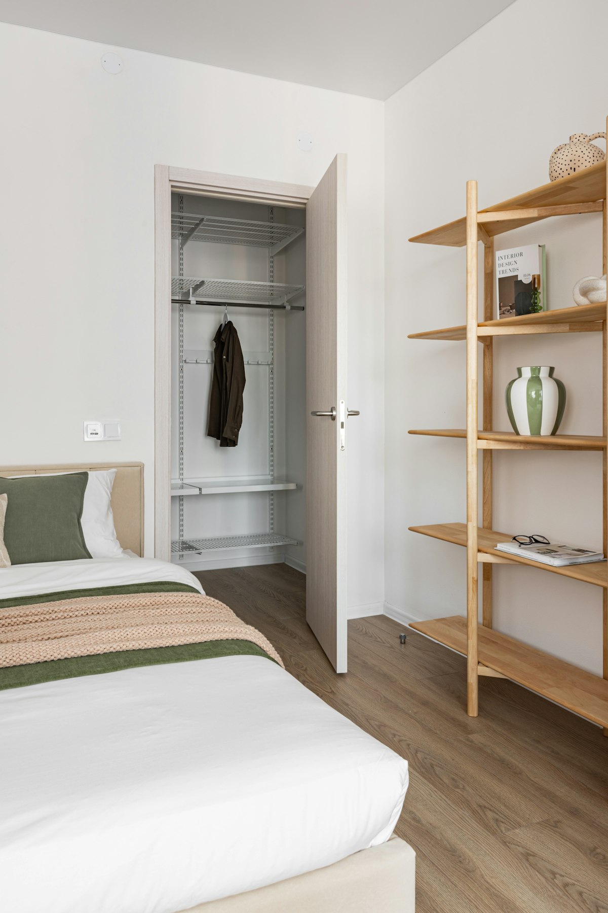 Bright open wardrobe with wooden shelves, well aired and tidy