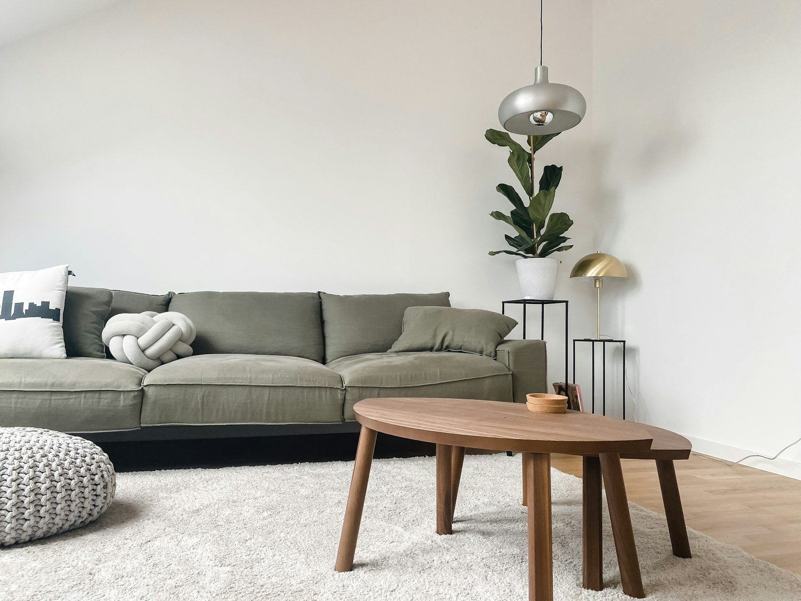 Modern living room with a gray two-seat fabric sofa and a wooden coffee table