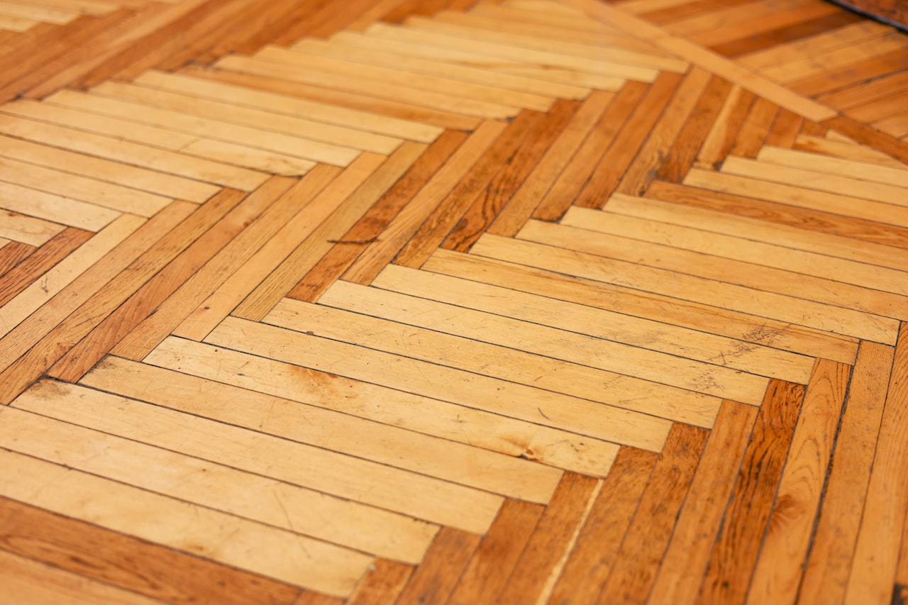 Close-up of a warm wooden parquet floor laid in a herringbone pattern