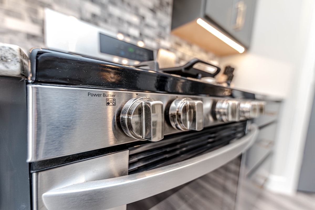 A close-up of a stovetop and oven in a modern kitchen
