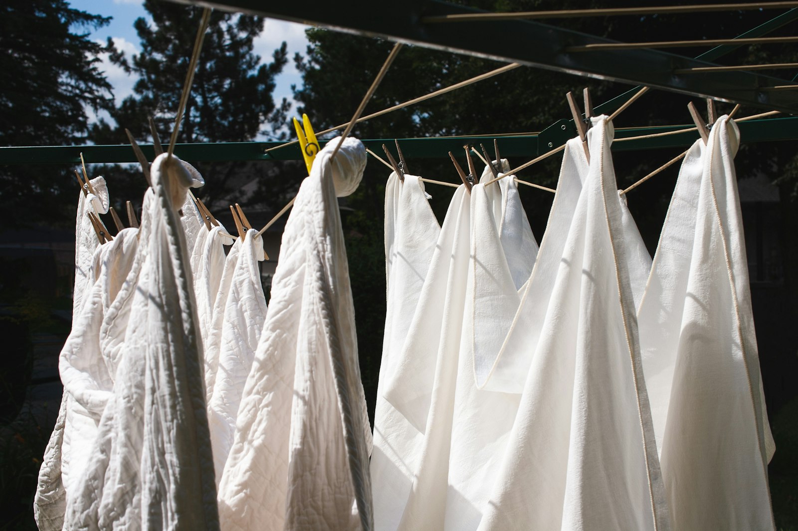 Fresh white laundry drying on a line in the open air