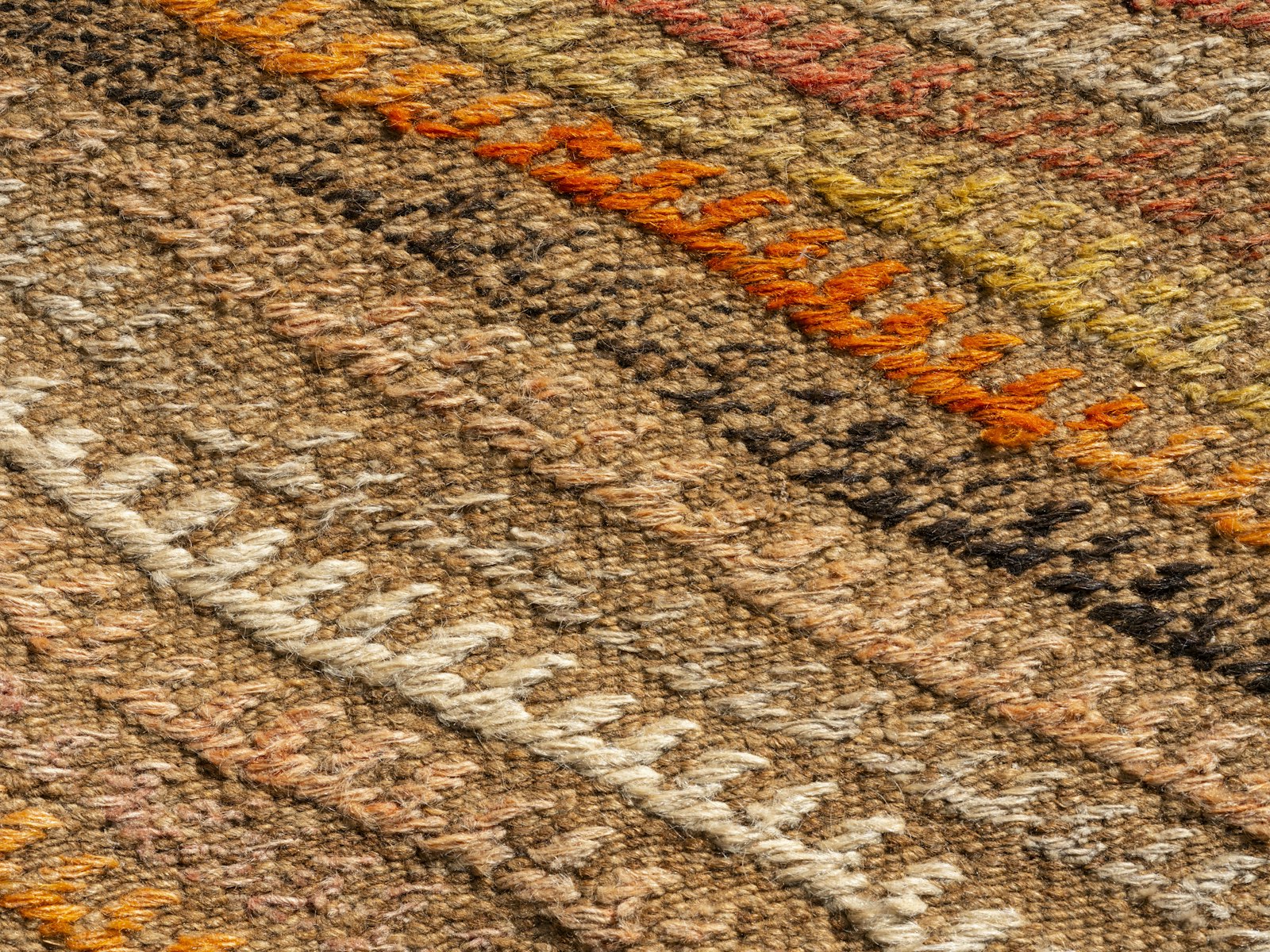 Close-up of a woven rug showing the depth of the pile and the yarn beneath the surface