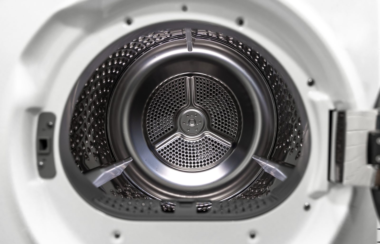 Close-up of a stainless steel washing machine drum viewed through the open door